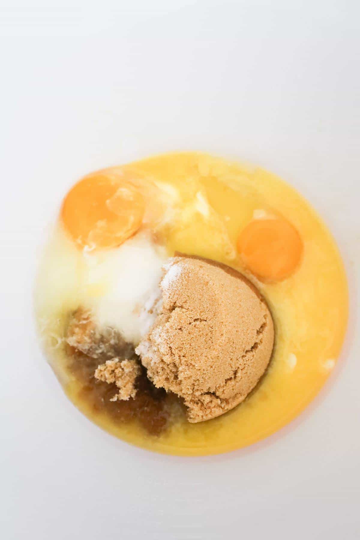brown sugar, granulated sugar, eggs and melted butter in a mixing bowl