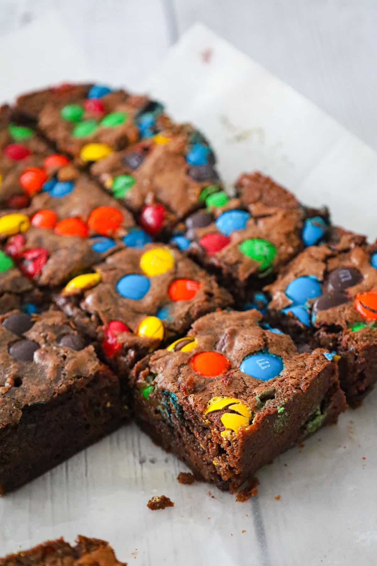 M&M Brownies are delicious fudgy brownies loaded with semi sweet chocolate chips and M&M's candies.