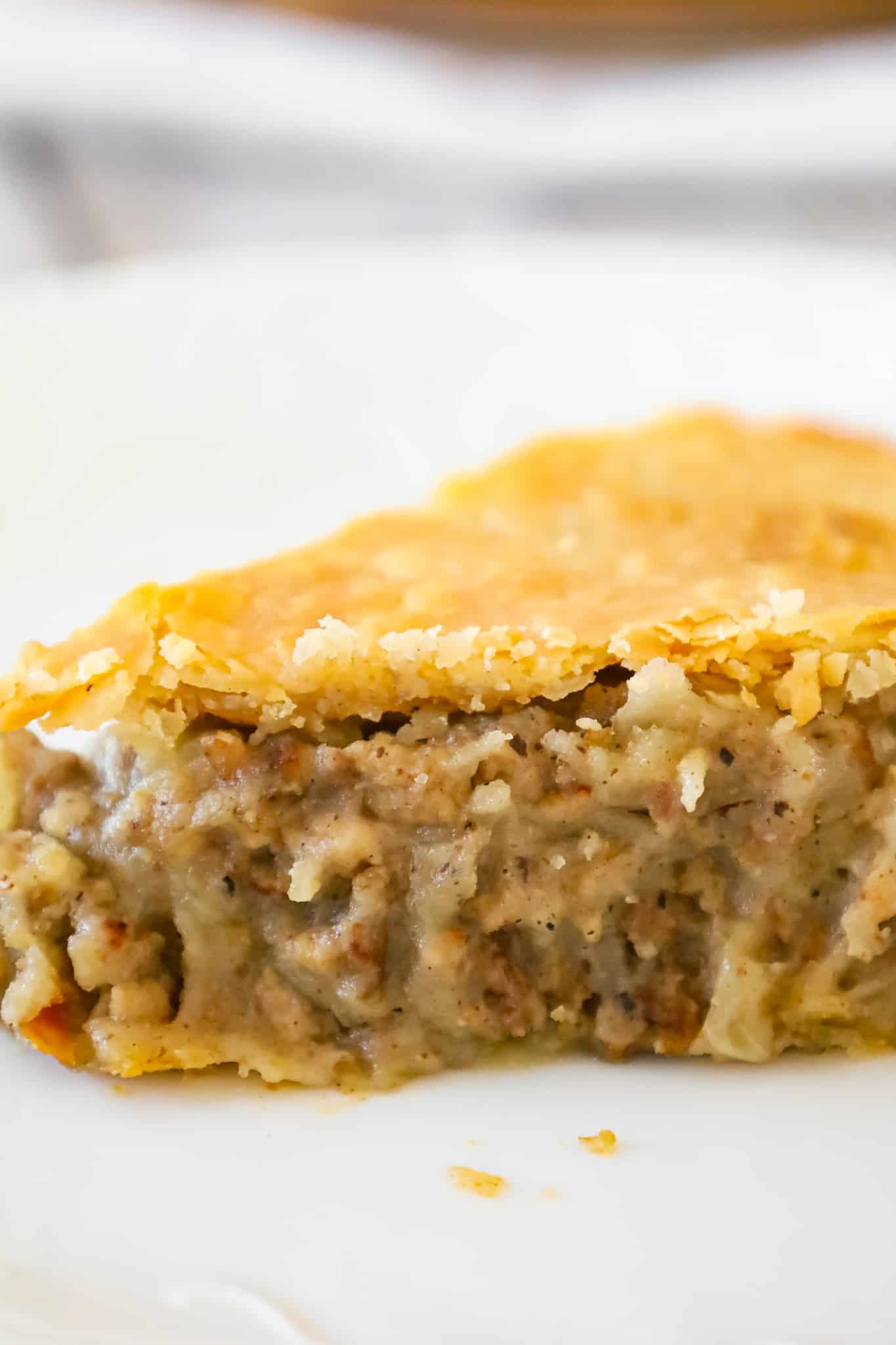 Meat Pie is a hearty dish made with ground beef, ground pork, mashed potatoes and spices all baked inside a flaky pie crust.