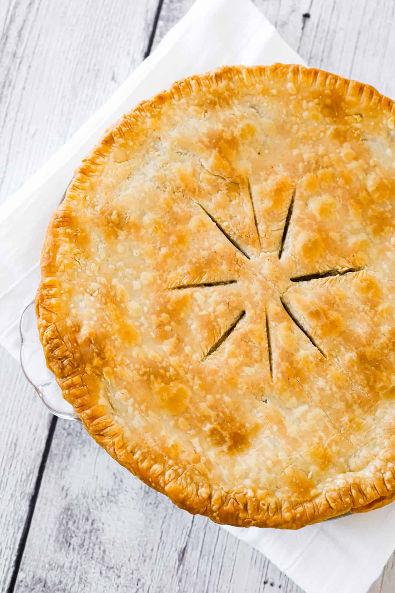 Meat Pie is a hearty dish made with ground beef, ground pork, mashed potatoes and spices all baked inside a flaky pie crust.