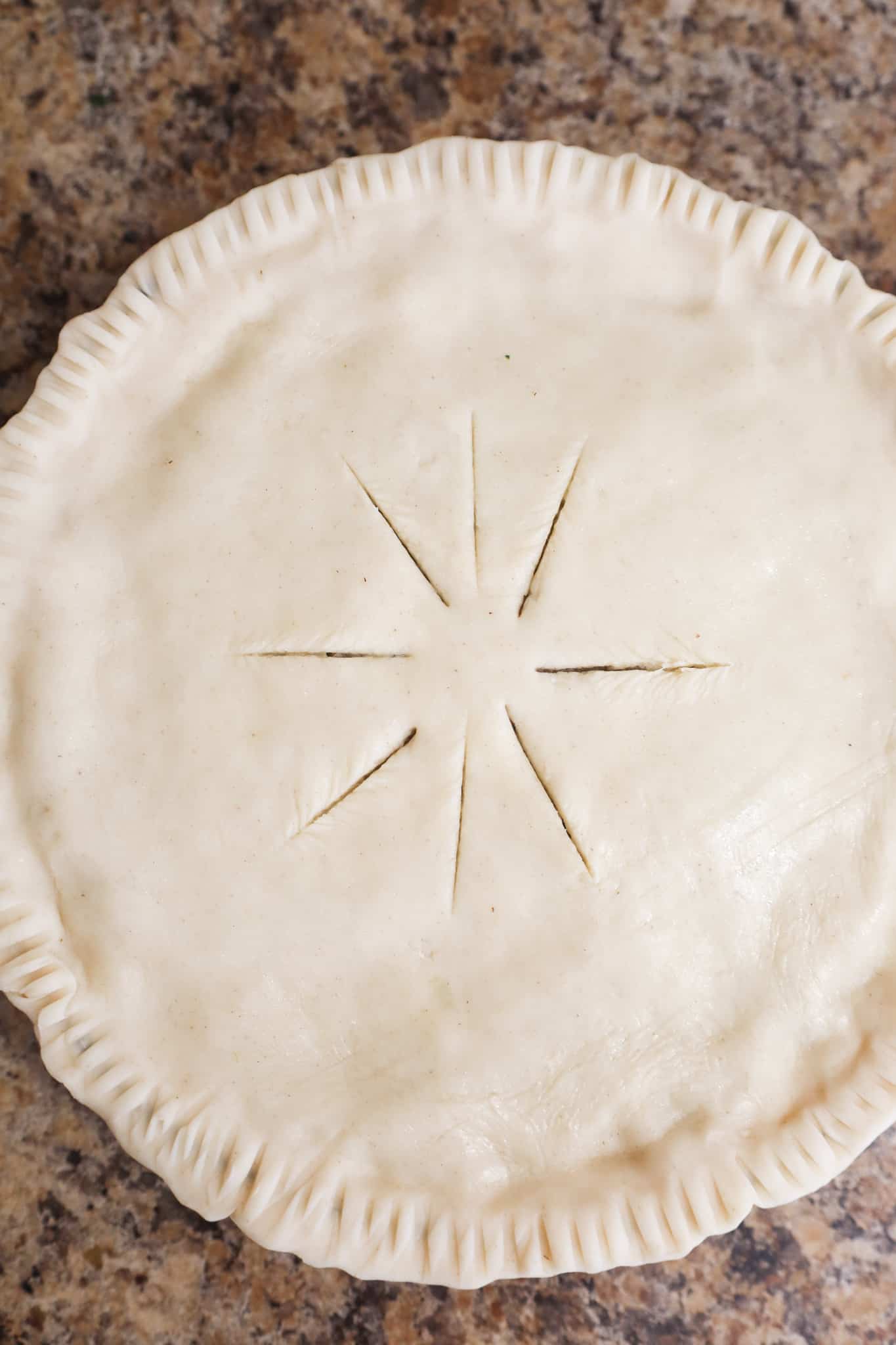 unbaked pie with slits in top crust