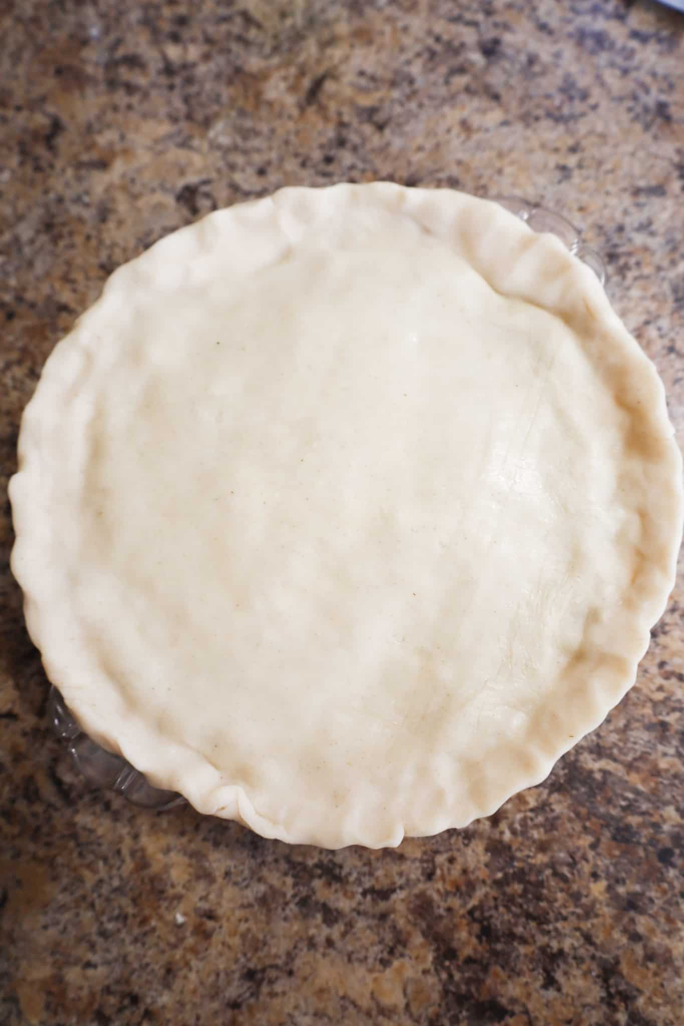 unbaked pie with trimmed crust