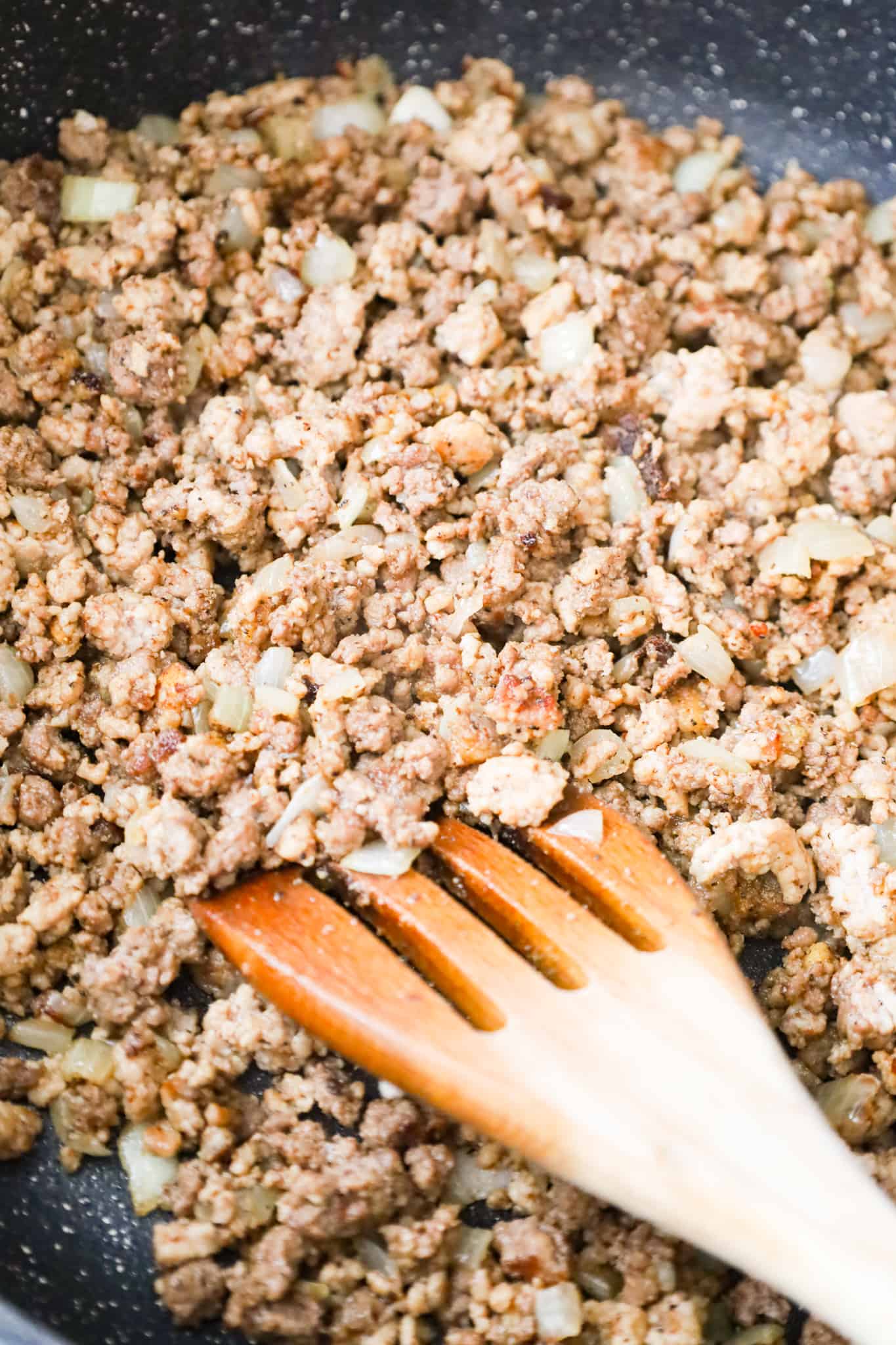 cooked ground beef, ground pork and diced onions in a saute pan