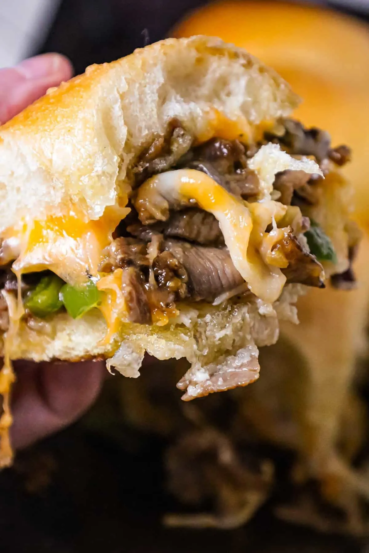Philly Cheese Steak Sliders are delicious mini sandwiches loaded with chopped roast beef, green peppers, onions and shredded cheese.