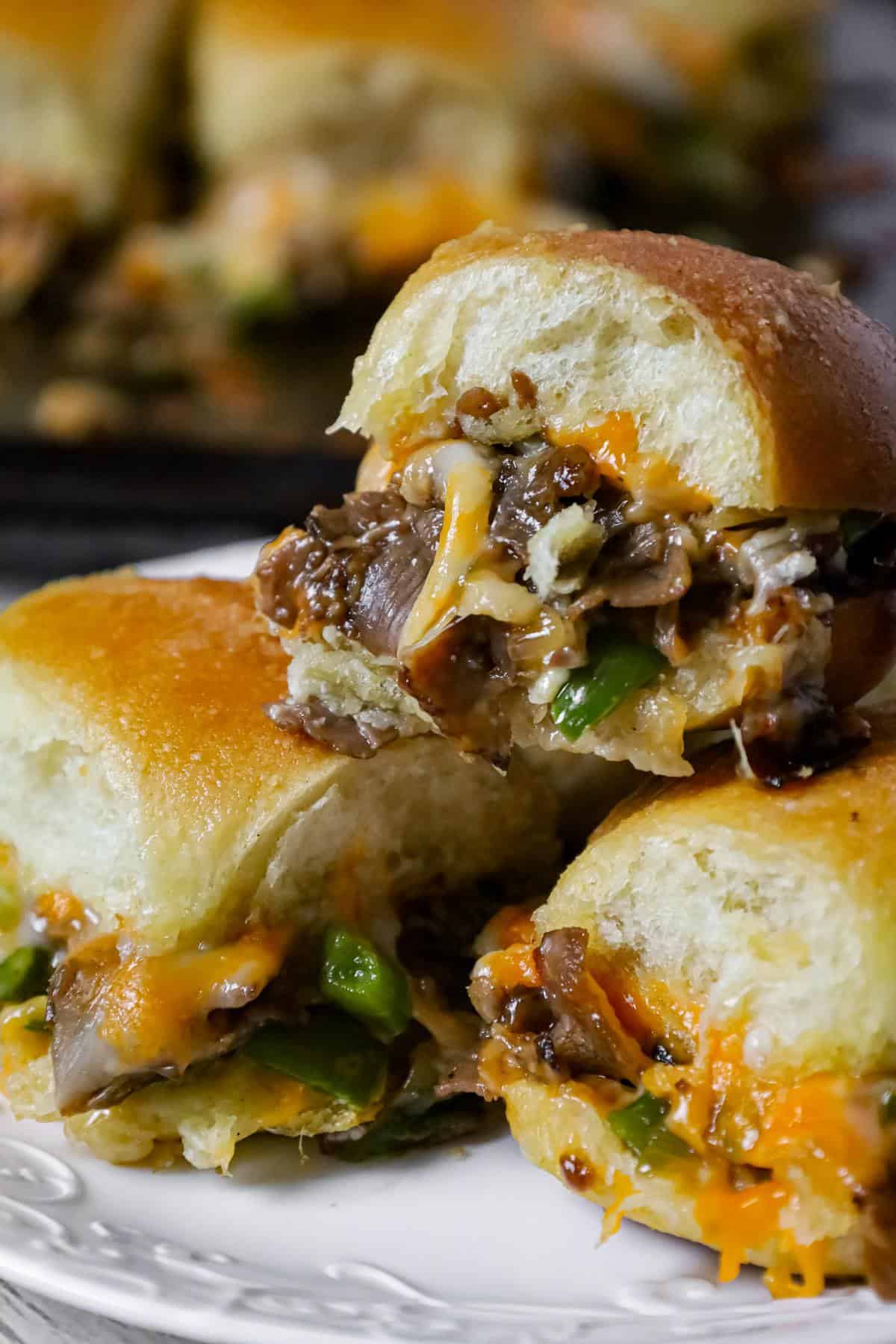 Philly Cheese Steak Sliders are delicious mini sandwiches loaded with chopped roast beef, green peppers, onions and shredded cheese.