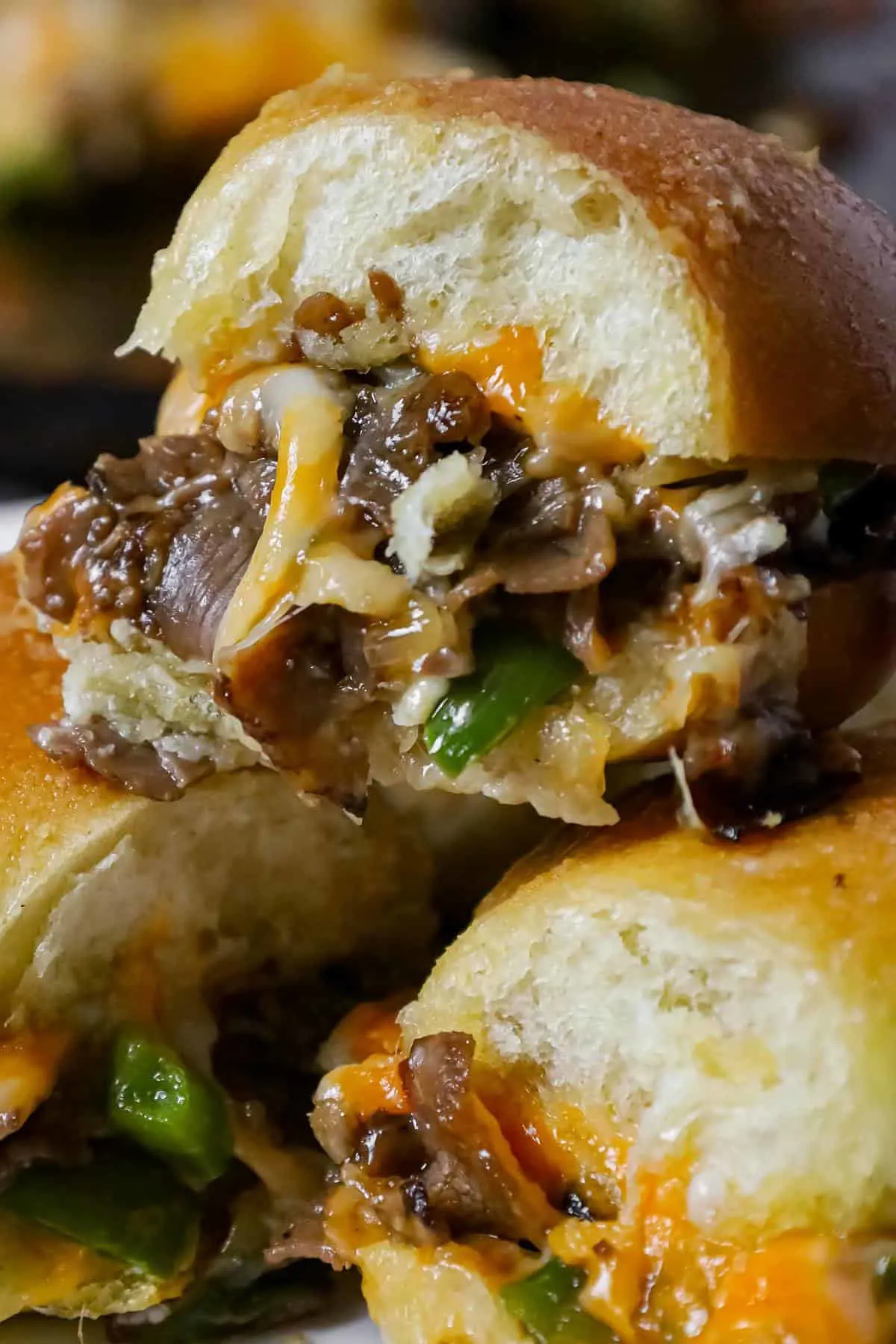 Philly Cheese Steak Sliders are delicious mini sandwiches loaded with chopped roast beef, green peppers, onions and shredded cheese.