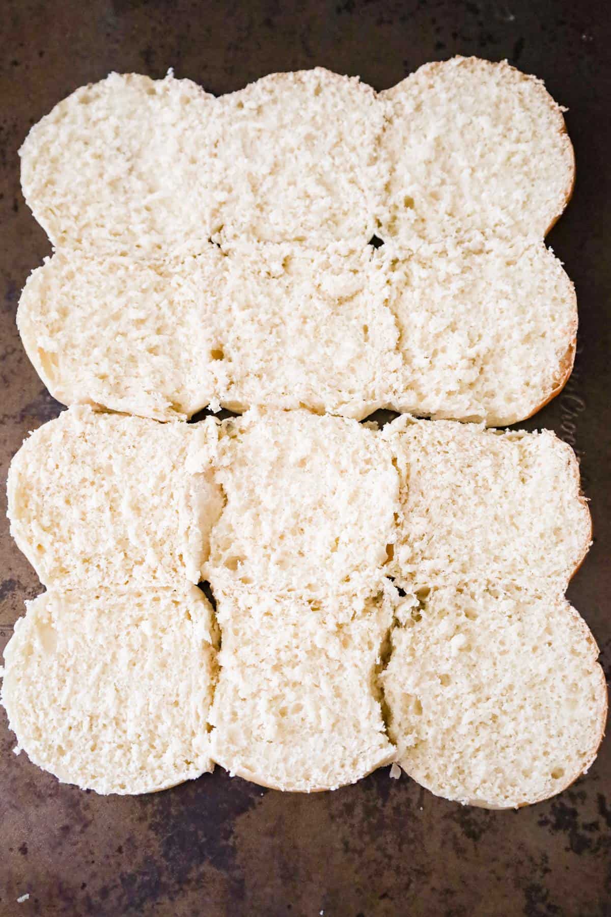 cut dinner rolls on a baking sheet