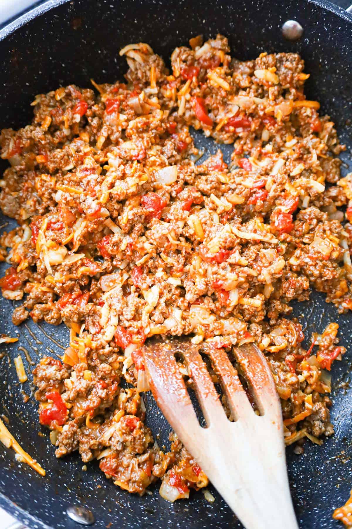 cheesy ground beef and Rotel mixture in a saute pan