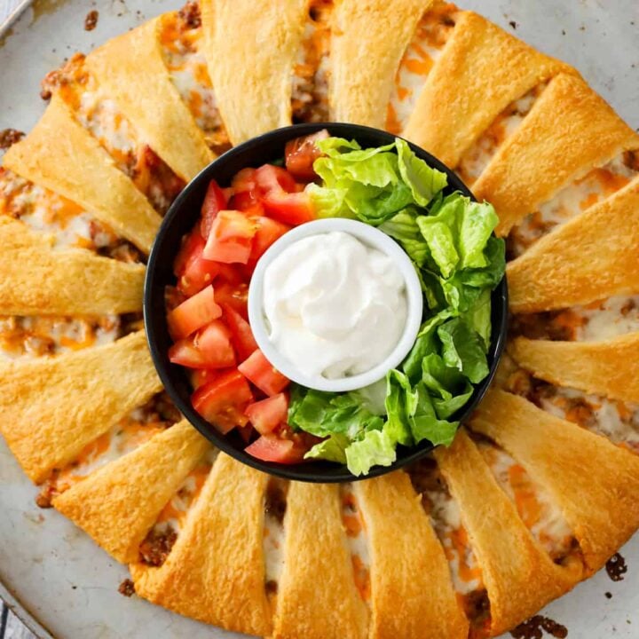 Taco Ring is an easy ground beef dinner recipe using Pillsbury crescent rolls and loaded with shredded cheese and Rotel diced tomatoes and green chilies.