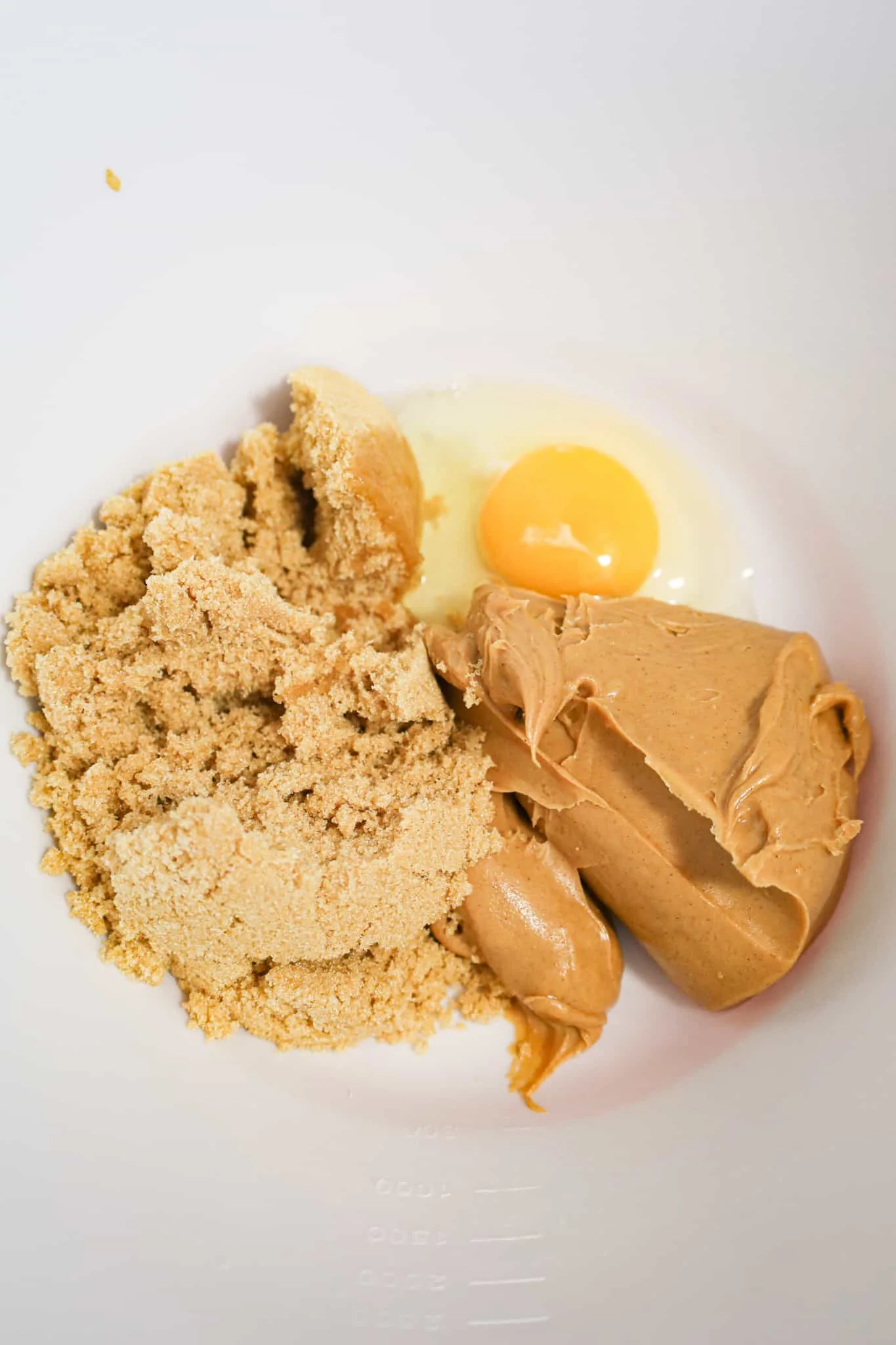light brown sugar, smooth peanut butter and an egg in the mixing bowl