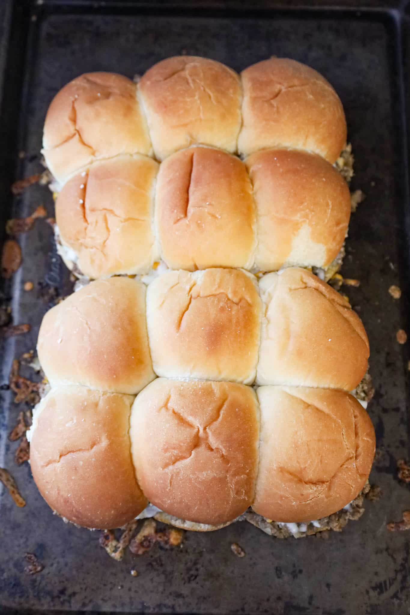 cheeseburger sliders on a baking sheet after baking