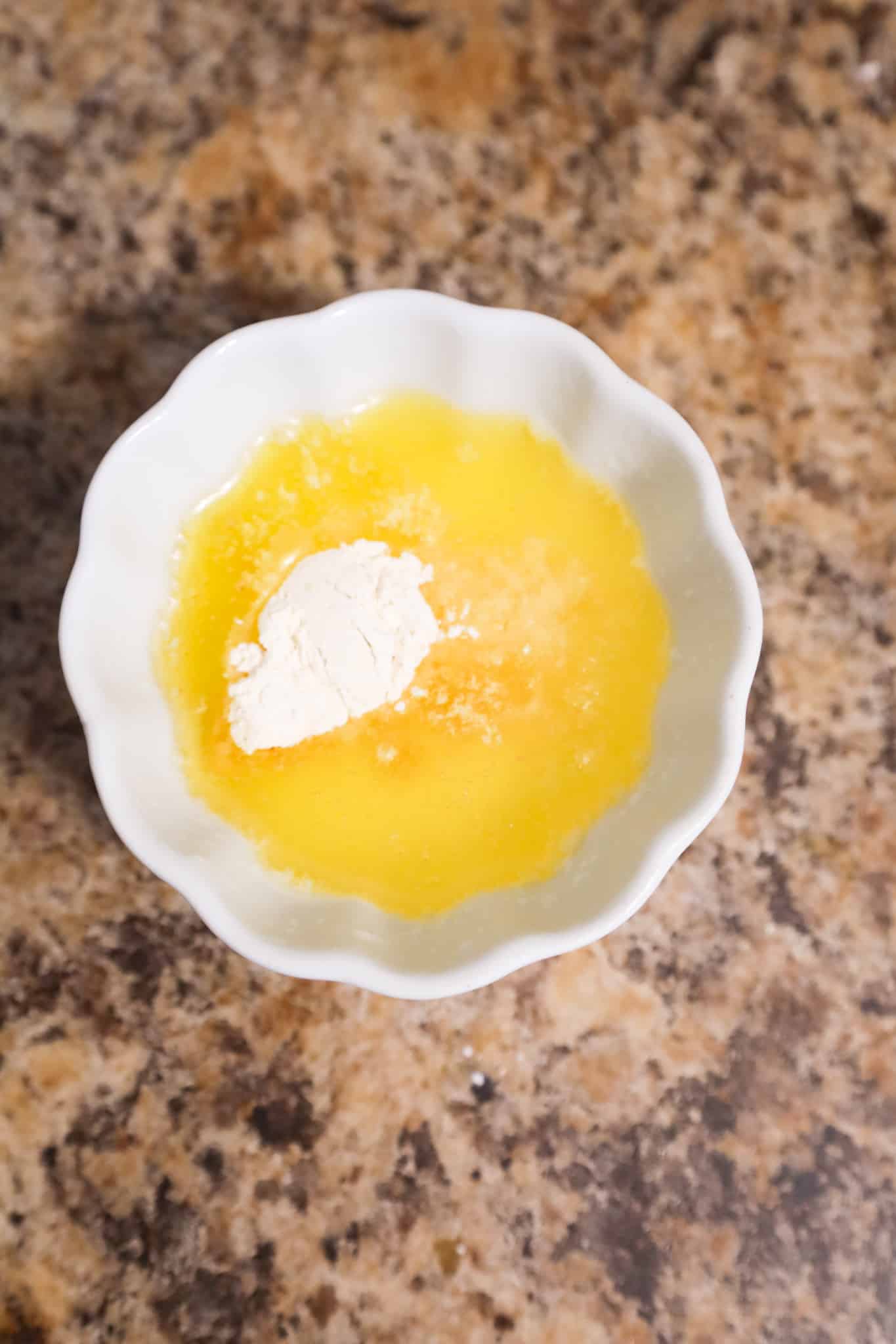 onion powder and garlic powder on in a bowl with melted butter