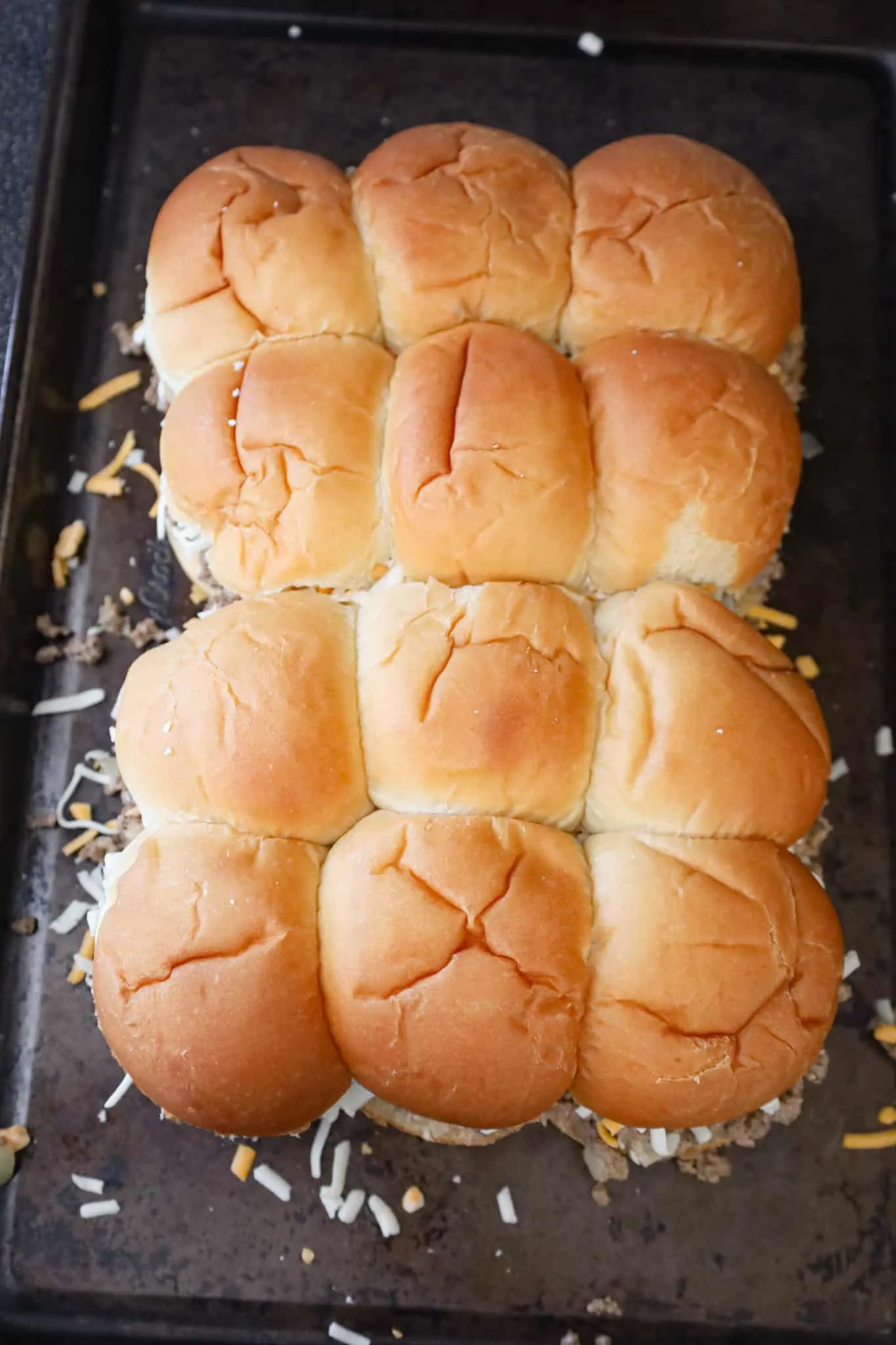 cheeseburger sliders on a baking sheet before baking