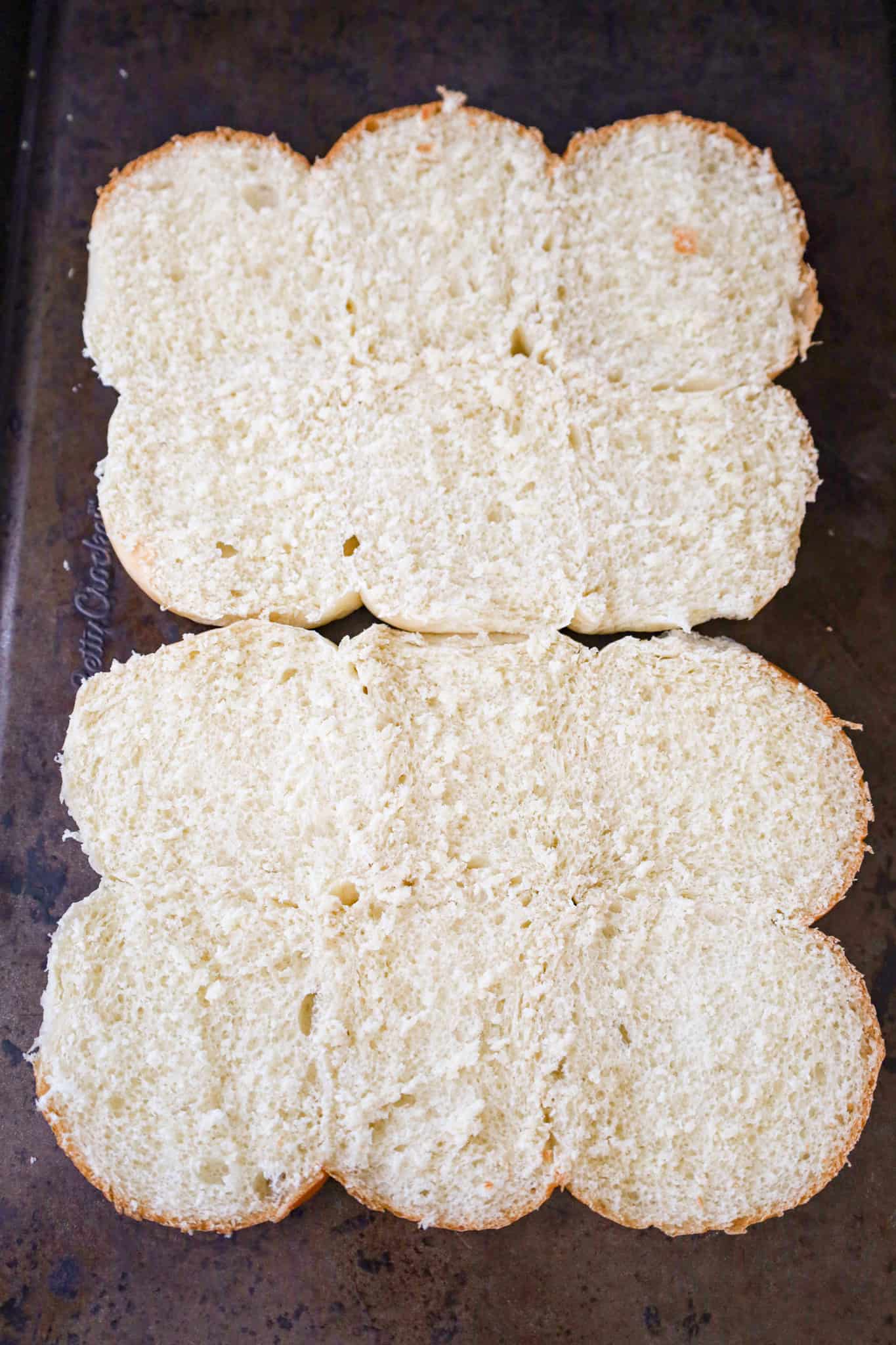bottoms halves of dinner rolls on a baking sheet