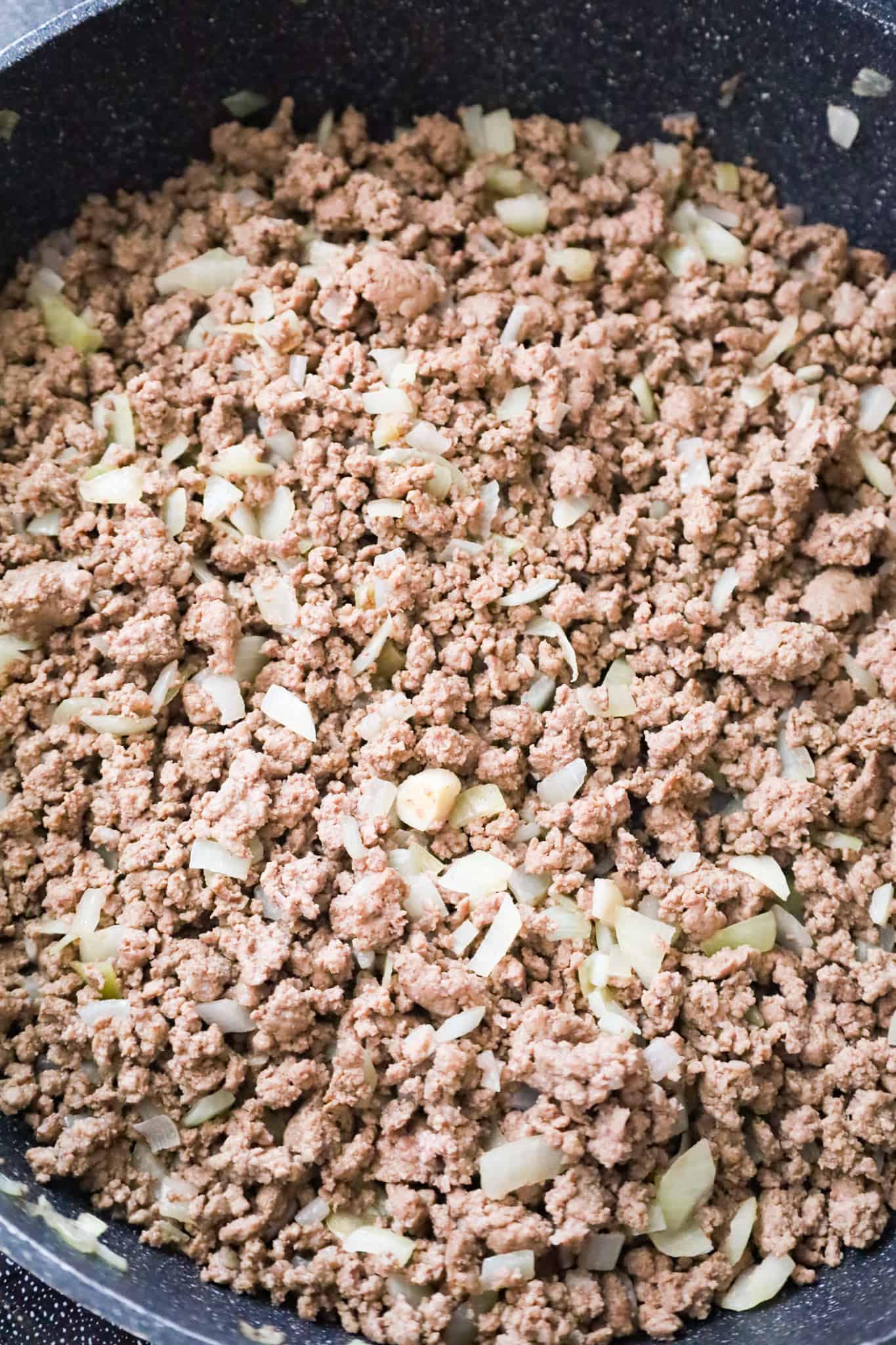 cooked ground beef and onions in a saute pan