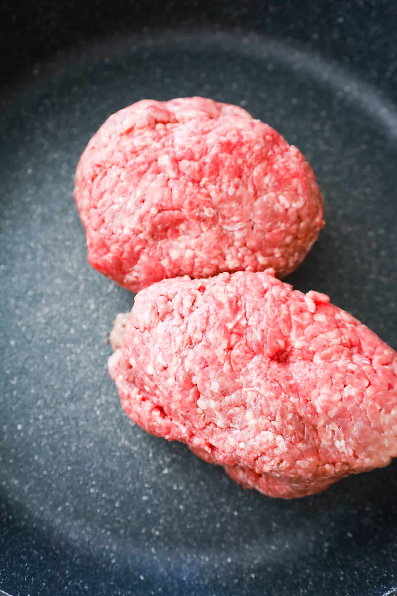 raw ground beef in a large saute pan