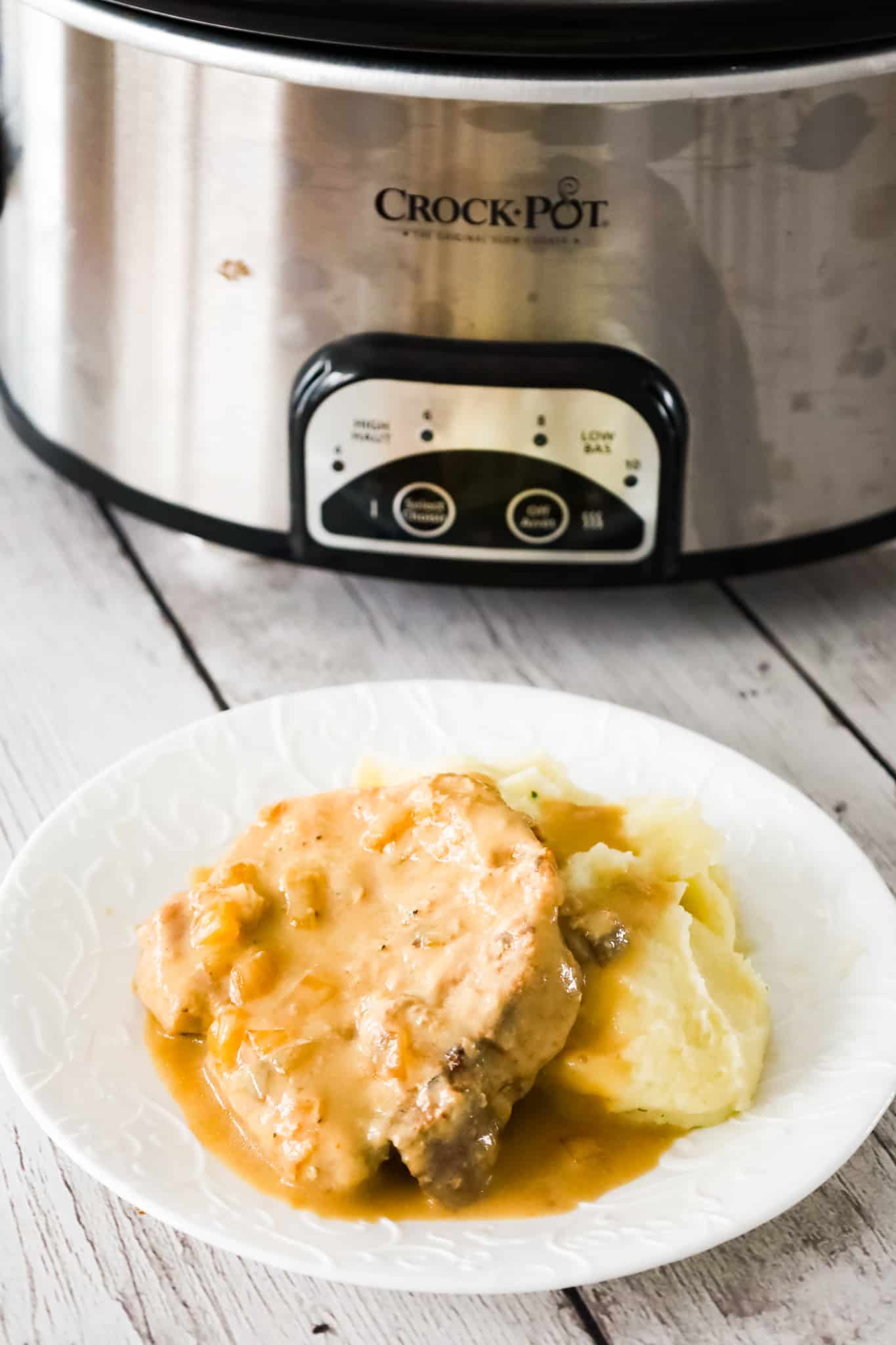 Crock Pot Pork Chops are a delicious slow cooker dinner recipe with bone in pork chops cooked in a creamy mushroom gravy.