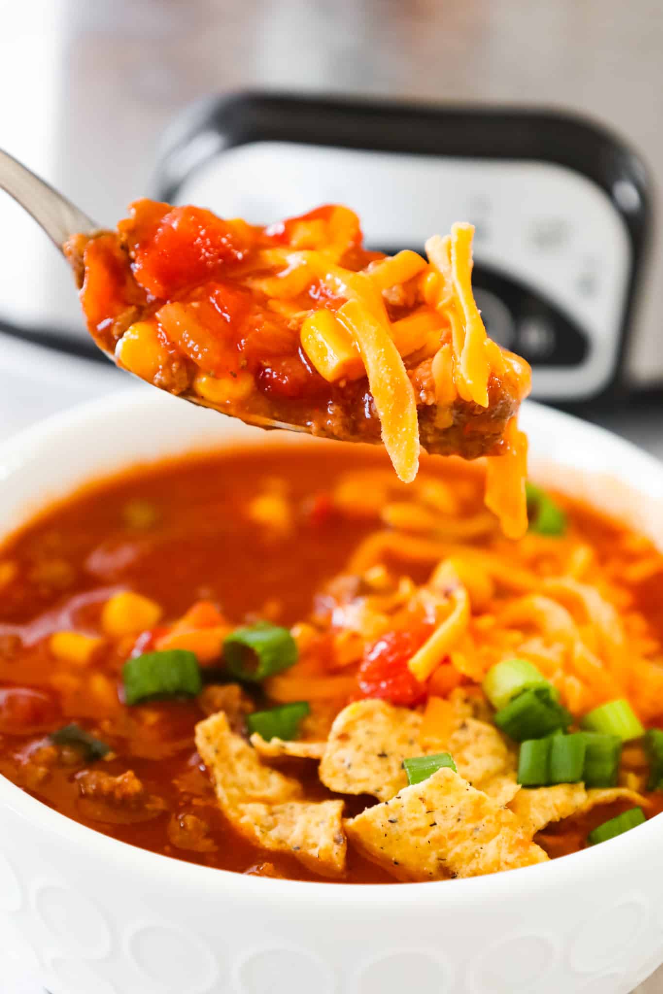 Crock Pot Taco Soup is an easy slow cooker soup recipe loaded with ground beef, Rotel diced tomatoes and green chilies, corn and chopped green onions.