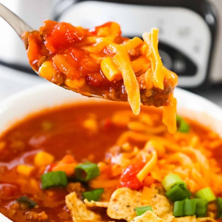 Crock Pot Taco Soup is an easy slow cooker soup recipe loaded with ground beef, Rotel diced tomatoes and green chilies, corn and chopped green onions.