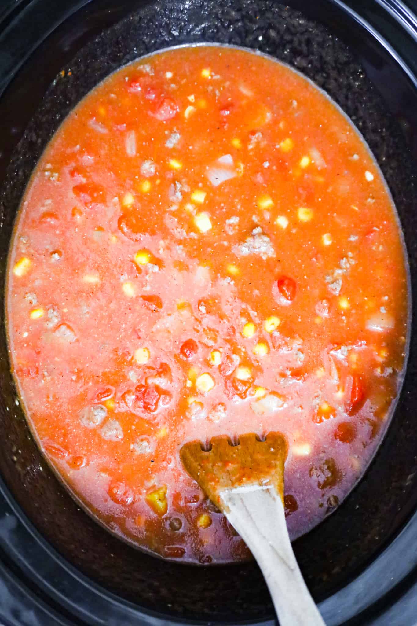 stirring beef taco soup in a crock pot