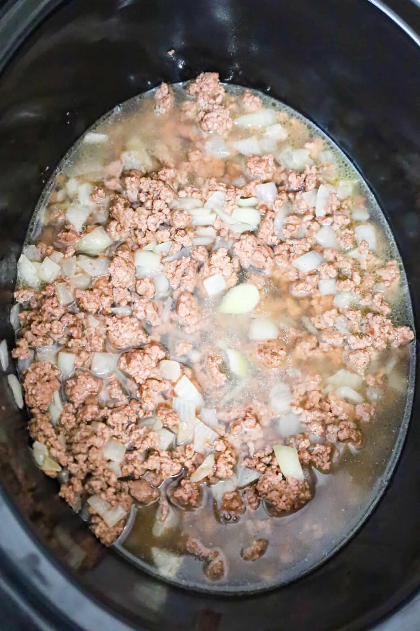 chicken broth, crumbled ground beef and diced onions in a crock pot