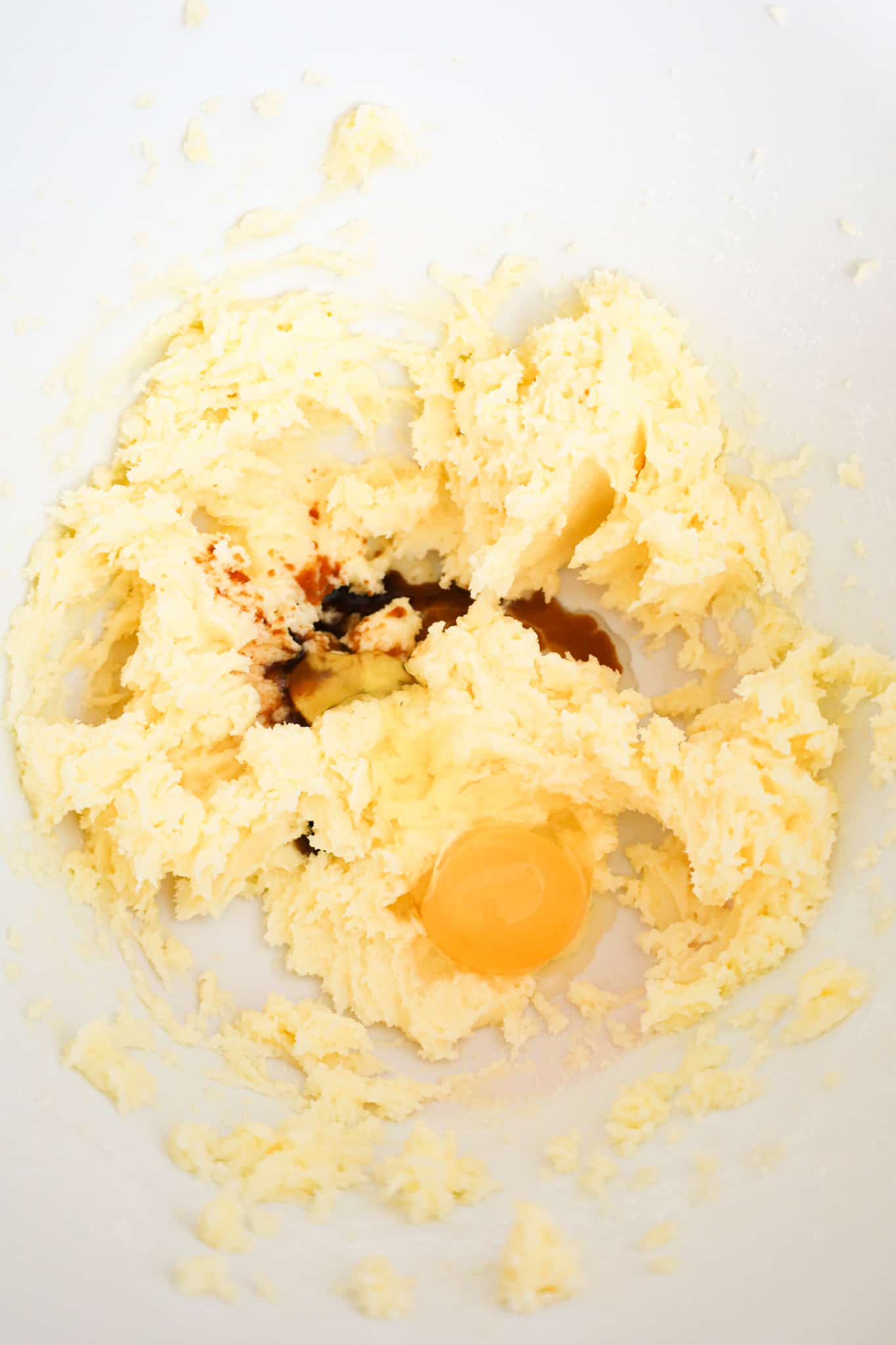 egg and vanilla extract added to creamed butter and sugar mixture in a mixing bowl