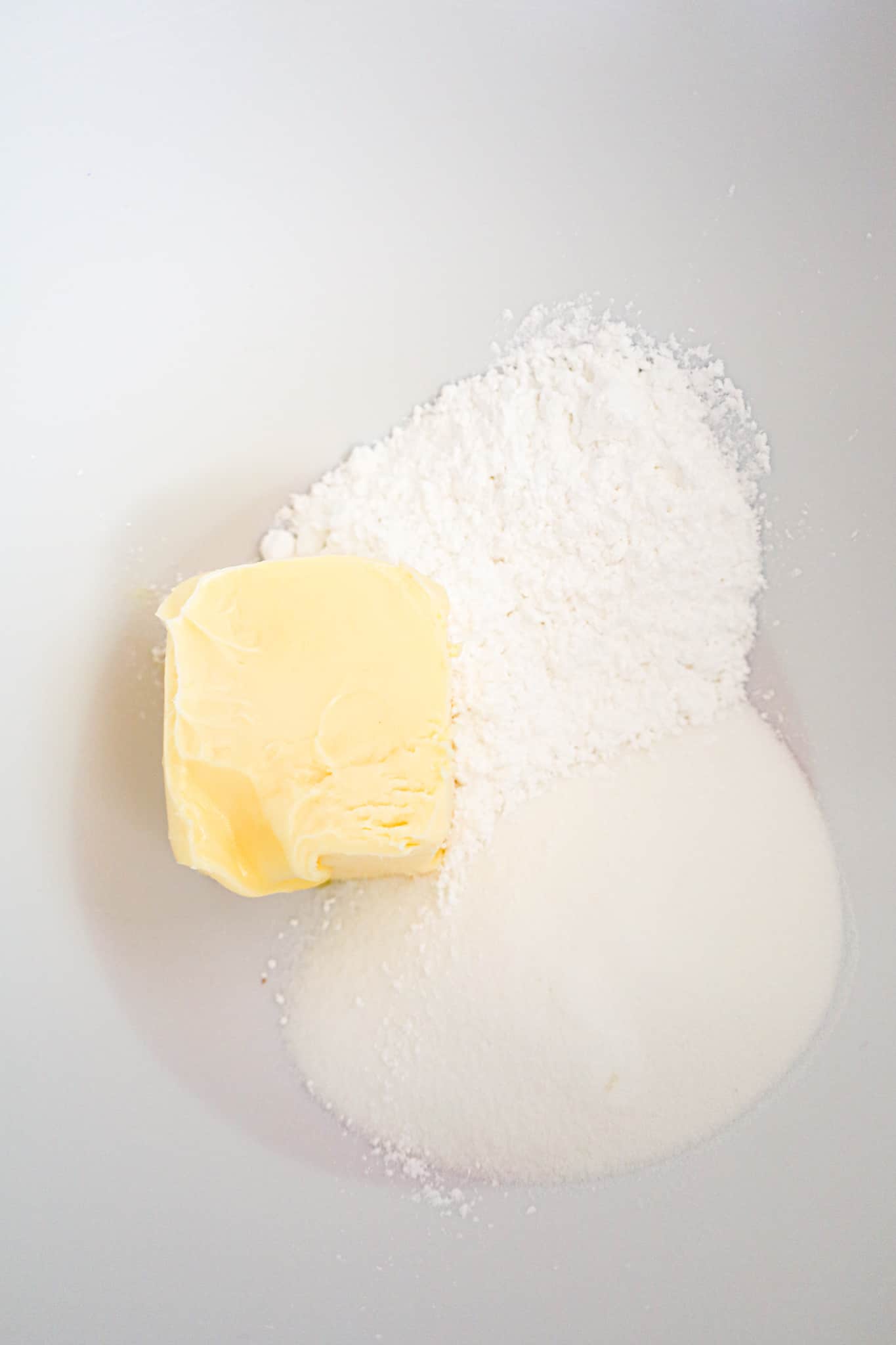 softened butter, granulated sugar and icing sugar in a mixing bowl