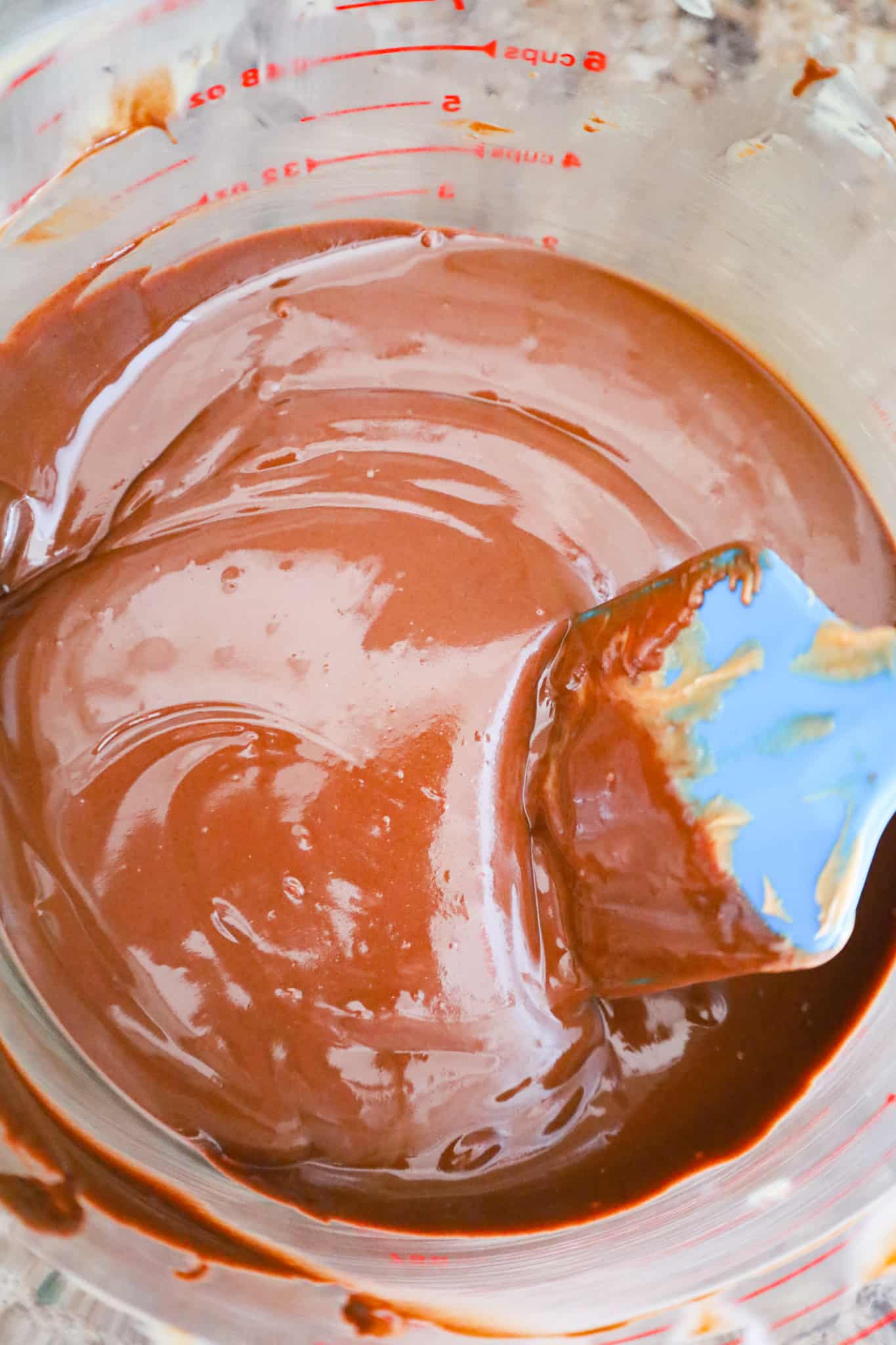 melted chocolate and peanut butter mixture in a large glass bowl