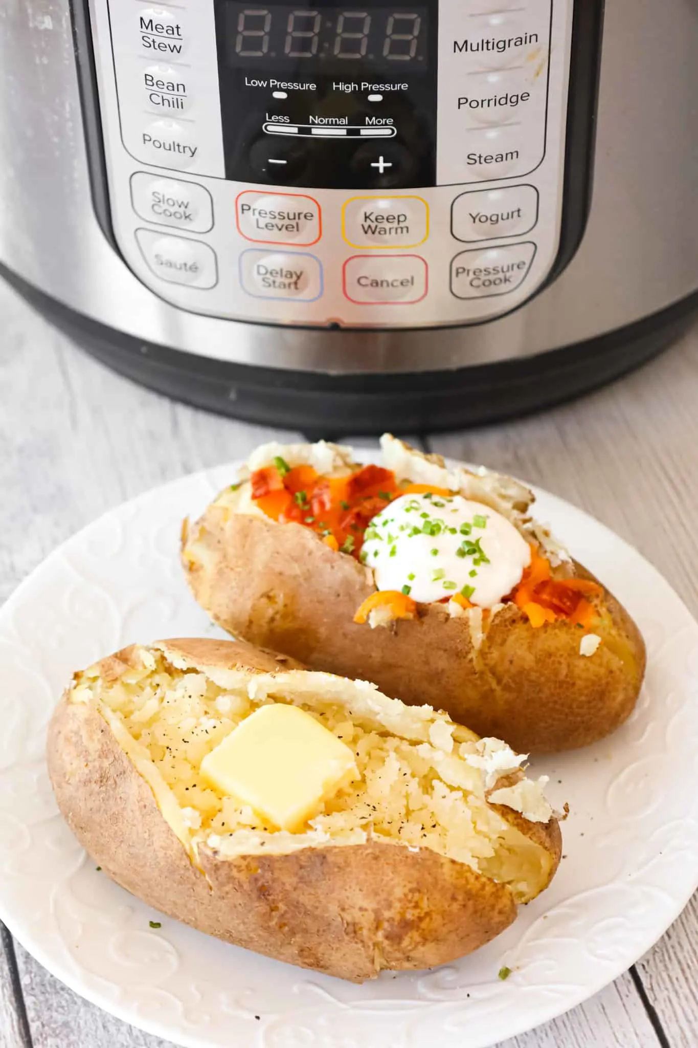 Instant Pot Baked Potatoes are a simple and delicious side dish recipe that can be topped with a variety of garnishes including butter, chives, sour cream, shredded cheese and crumbled bacon.