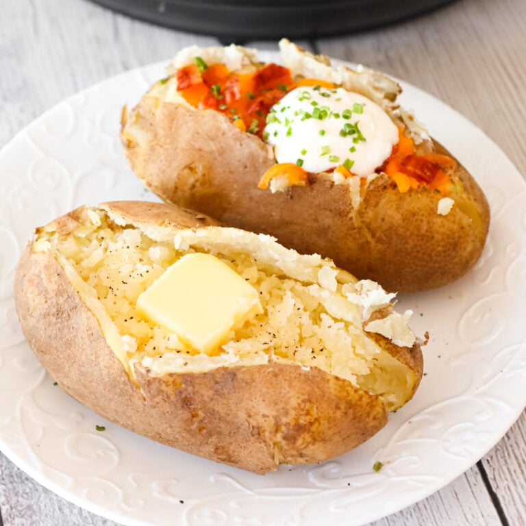 Instant Pot Baked Potatoes are a simple and delicious side dish recipe that can be topped with a variety of garnishes including butter, chives, sour cream, shredded cheese and crumbled bacon.
