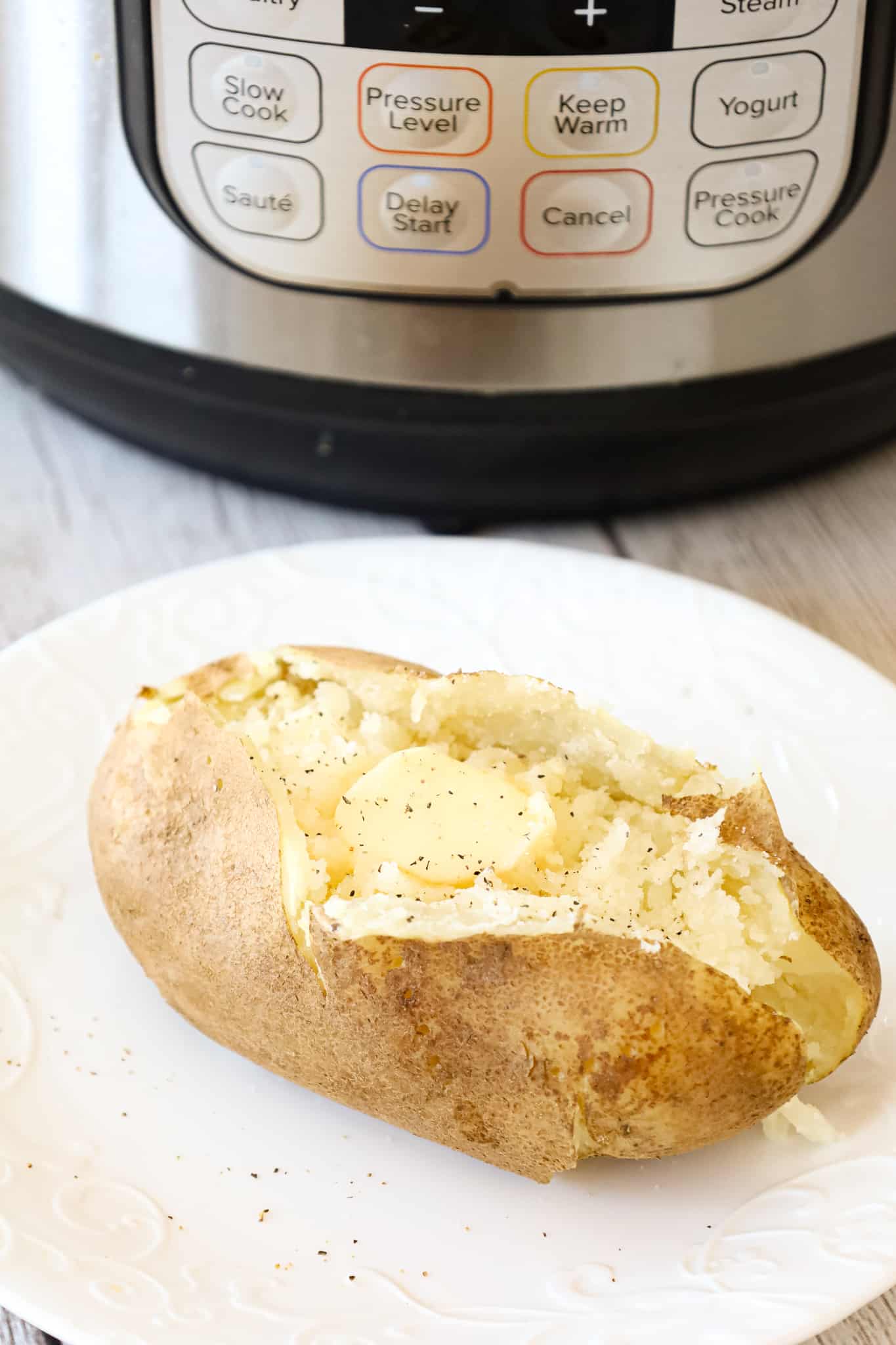 Instant Pot Baked Potatoes are a simple and delicious side dish recipe that can be topped with a variety of garnishes including butter, chives, sour cream, shredded cheese and crumbled bacon.