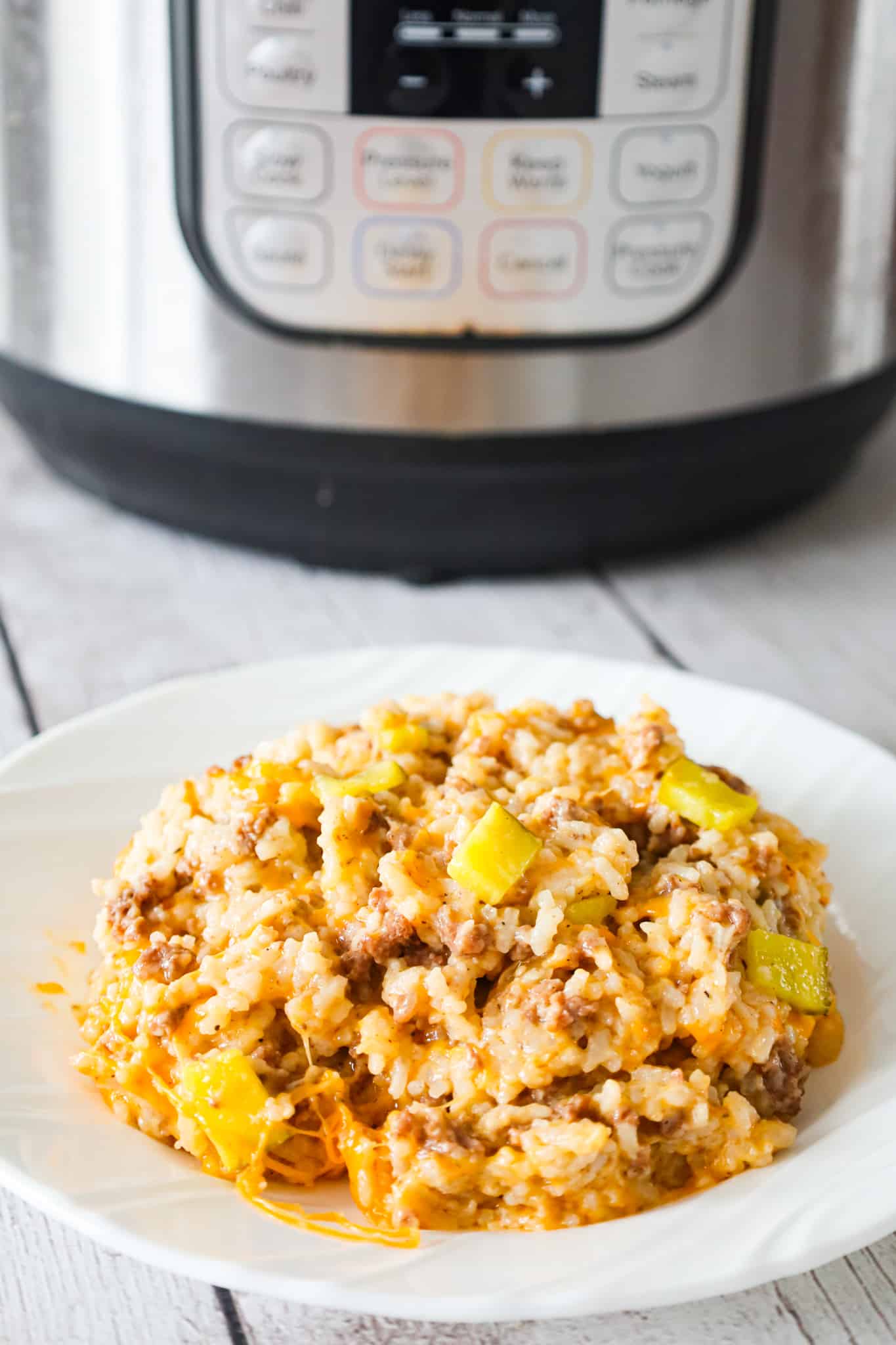 Instant Pot Big Mac Ground Beef and Rice is an easy pressure cooker dinner recipe made with long grain white rice and loaded with crumbled ground beef, diced dill pickles, mayo, Thousand Island dressing and shredded cheddar cheese.