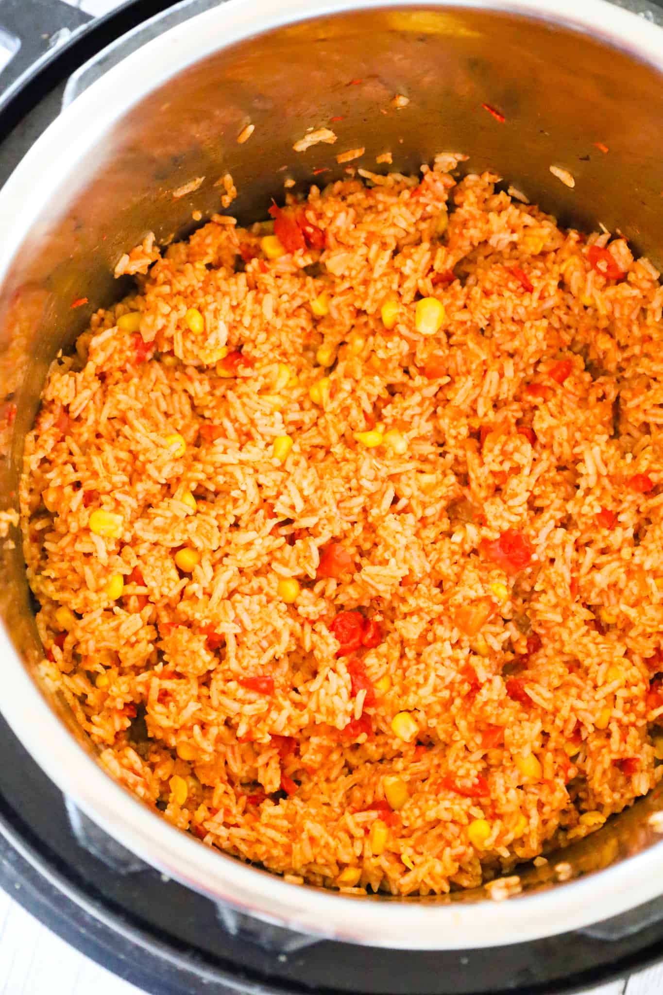 Instant Pot Spanish Rice is a delicious pressure cooker side dish recipe made with long grain white rice and loaded with Rotel diced tomatoes and green chilies, corn and flavourful spices.