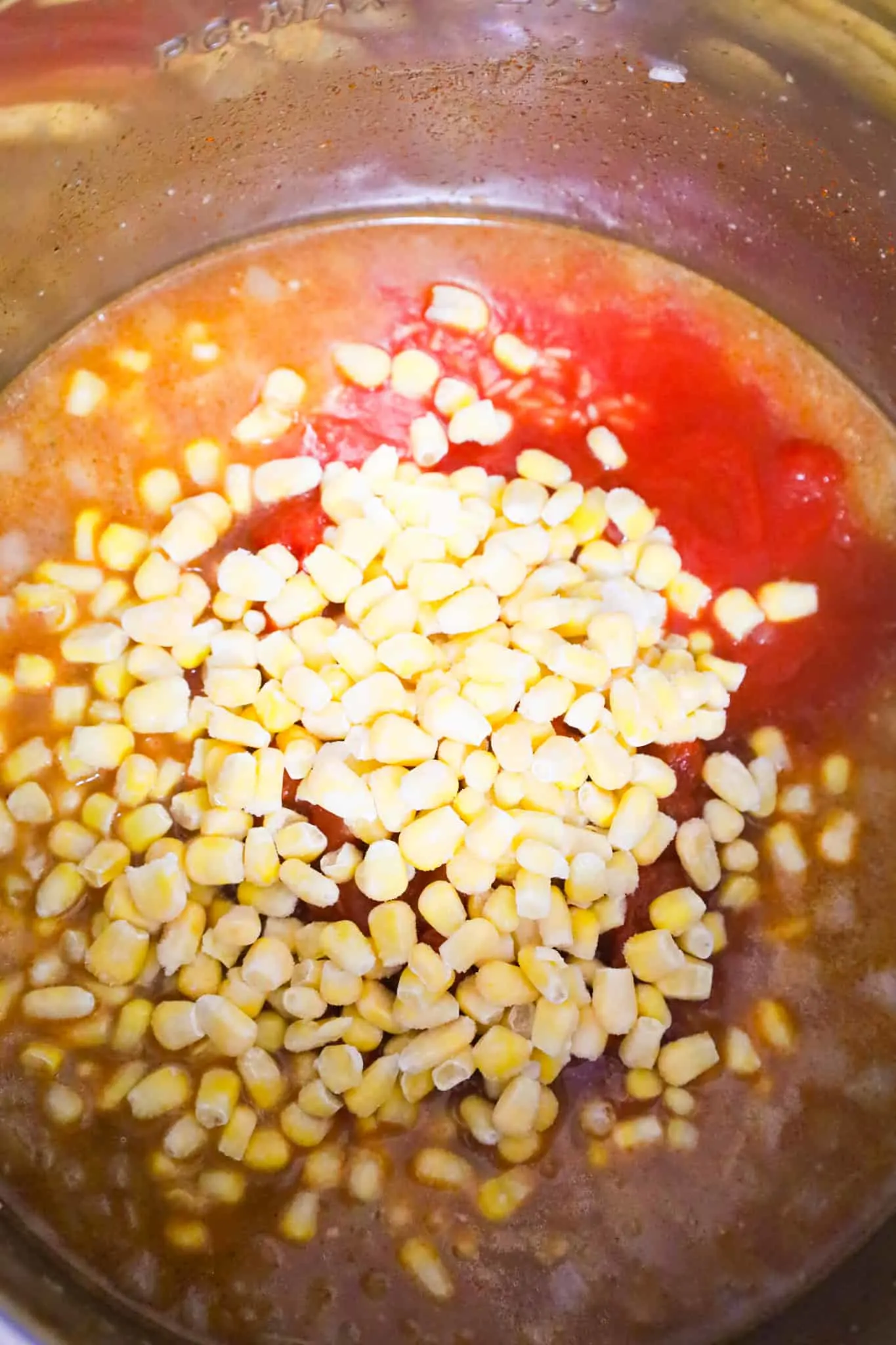 frozen corn kernels on top of Rotel, tomato sauce, chicken broth and rice
