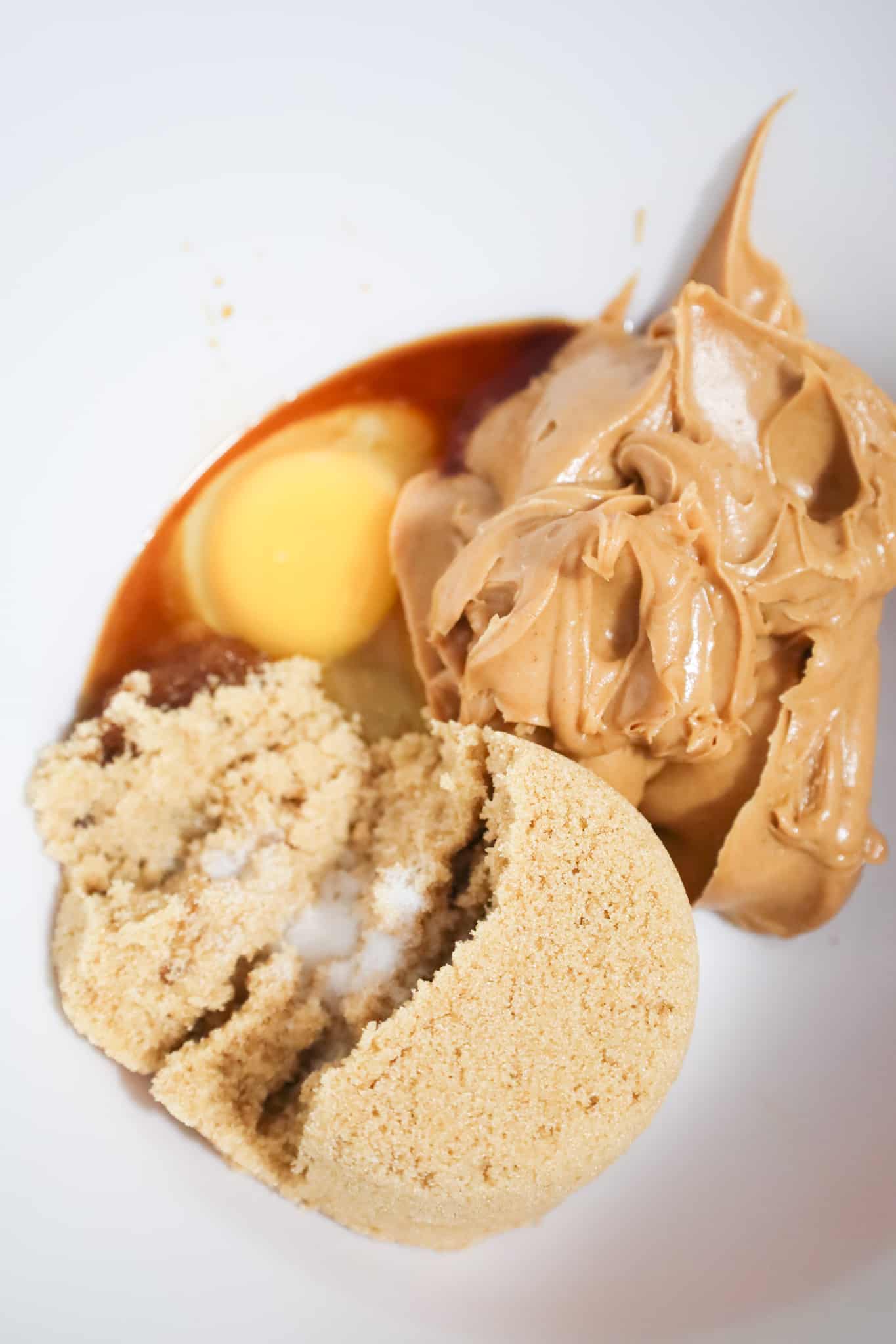 smooth peanut butter, brown sugar, an egg and vanilla extract in a mixing bowl
