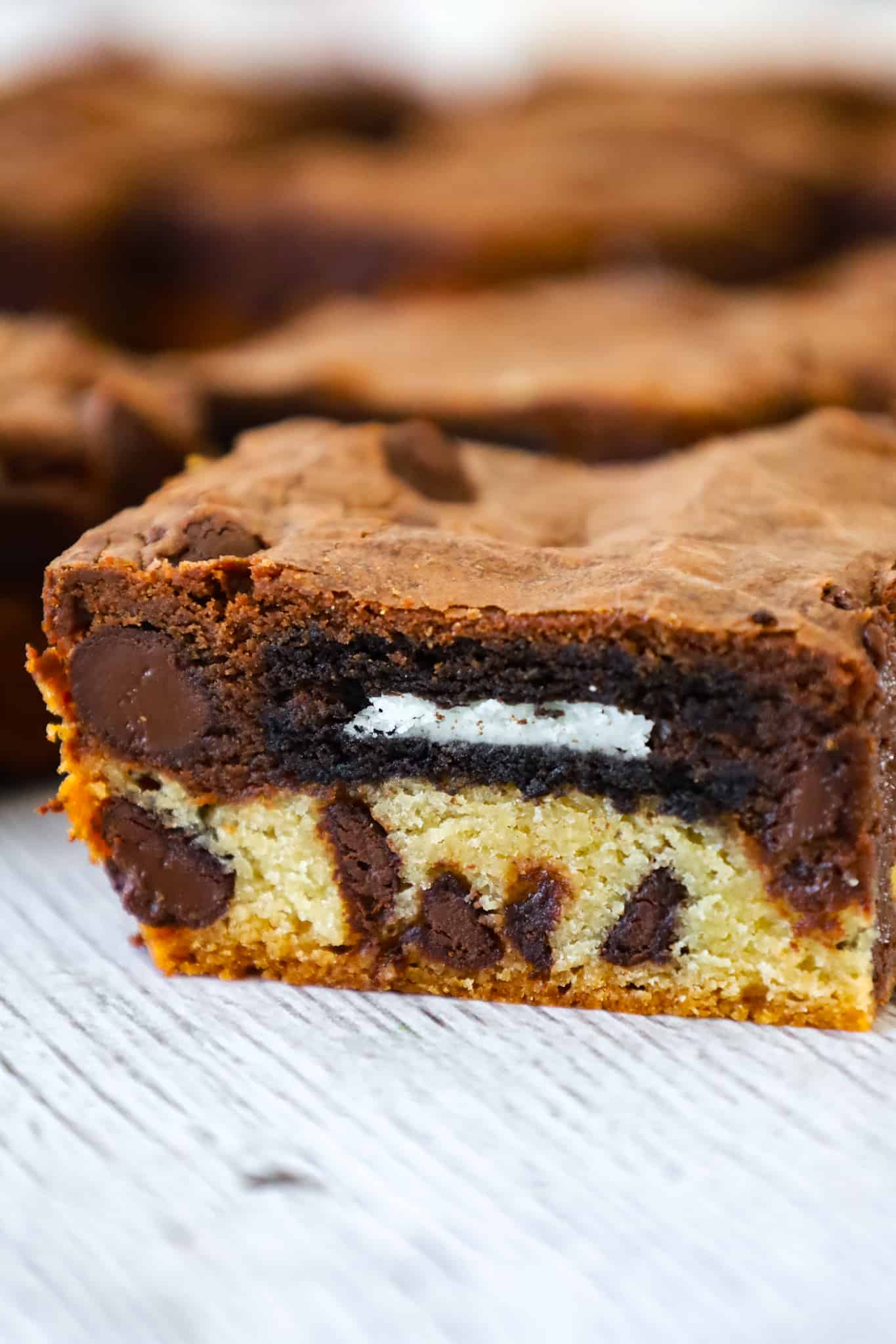 Slutty Brownies are delicious triple layer brownies with a chocolate chip cookie base, Oreo middle and chocolate brownie batter on top.