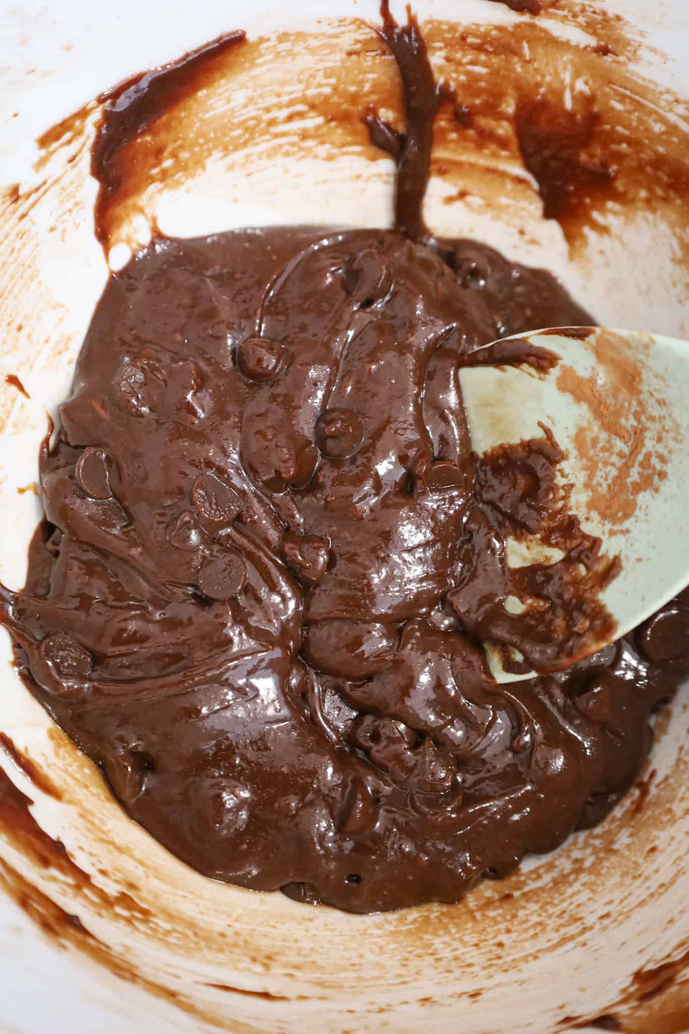 chocolate chips stirred into brownie batter in a mixing bowl