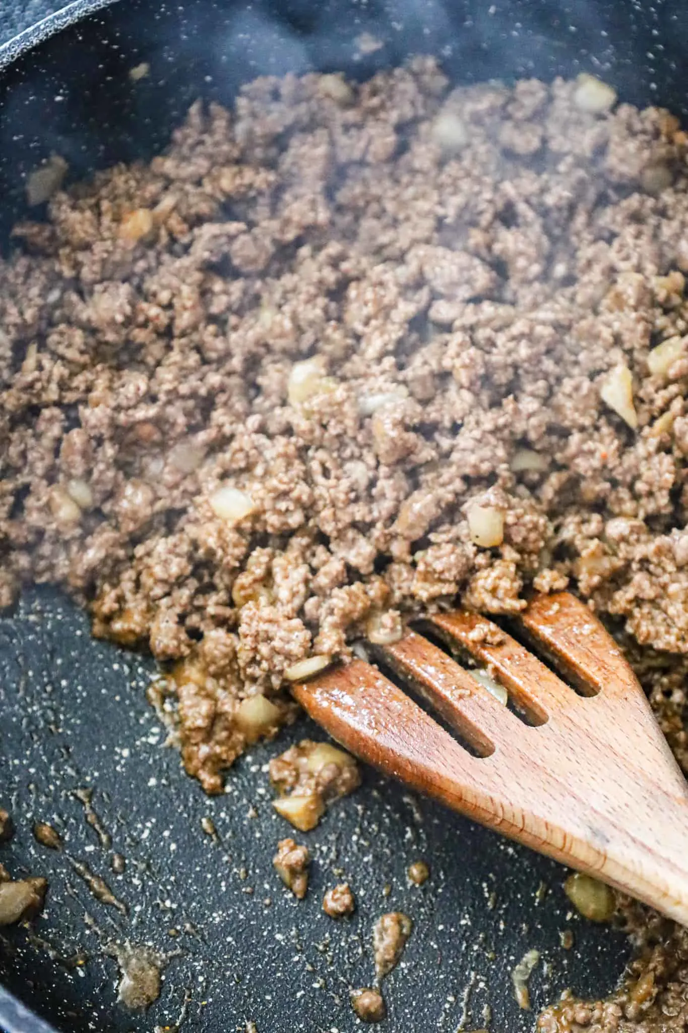 ground beef and taco seasoning simmering in a saute pan