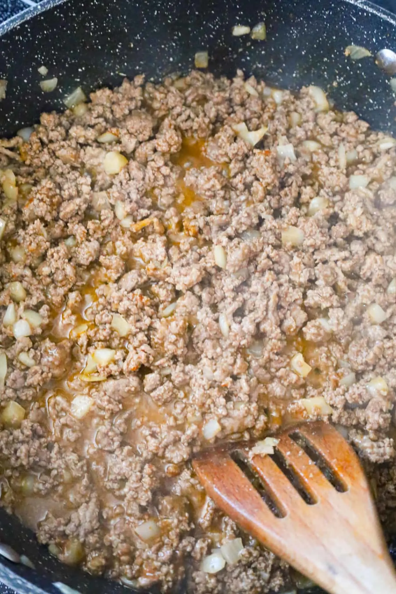 ground beef and taco seasoning mixture simmering in a saute pan