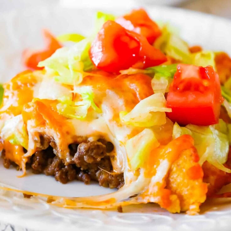 Walking Taco Casserole is an easy ground beef dinner recipe loaded with diced onions, Fritos corn chips, shredded nacho cheese blend, lettuce and diced tomatoes.