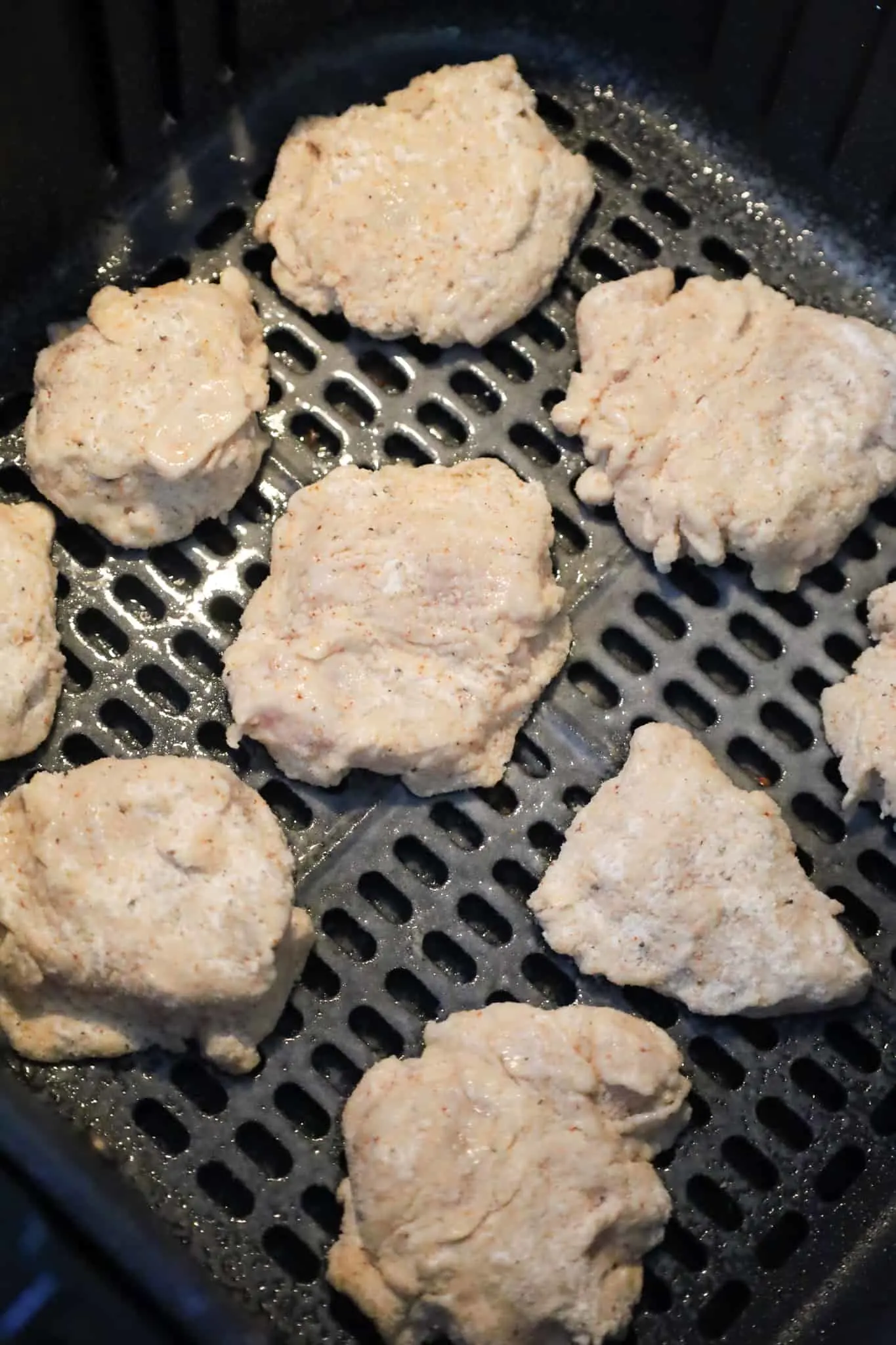 chicken nuggets in the air fryer sprayed with cooking oil