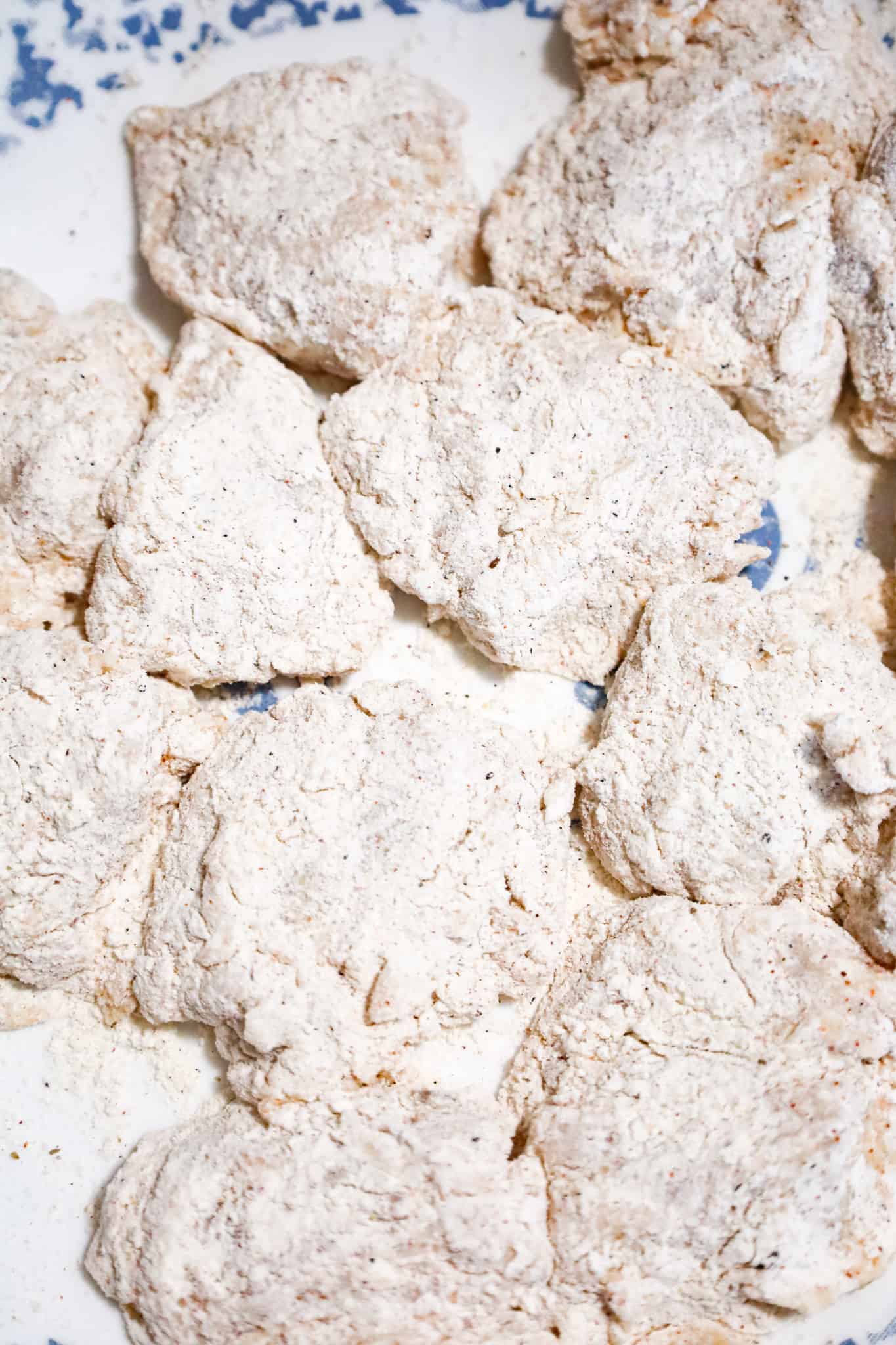 pieces of chicken coated in flour mixture on a plate