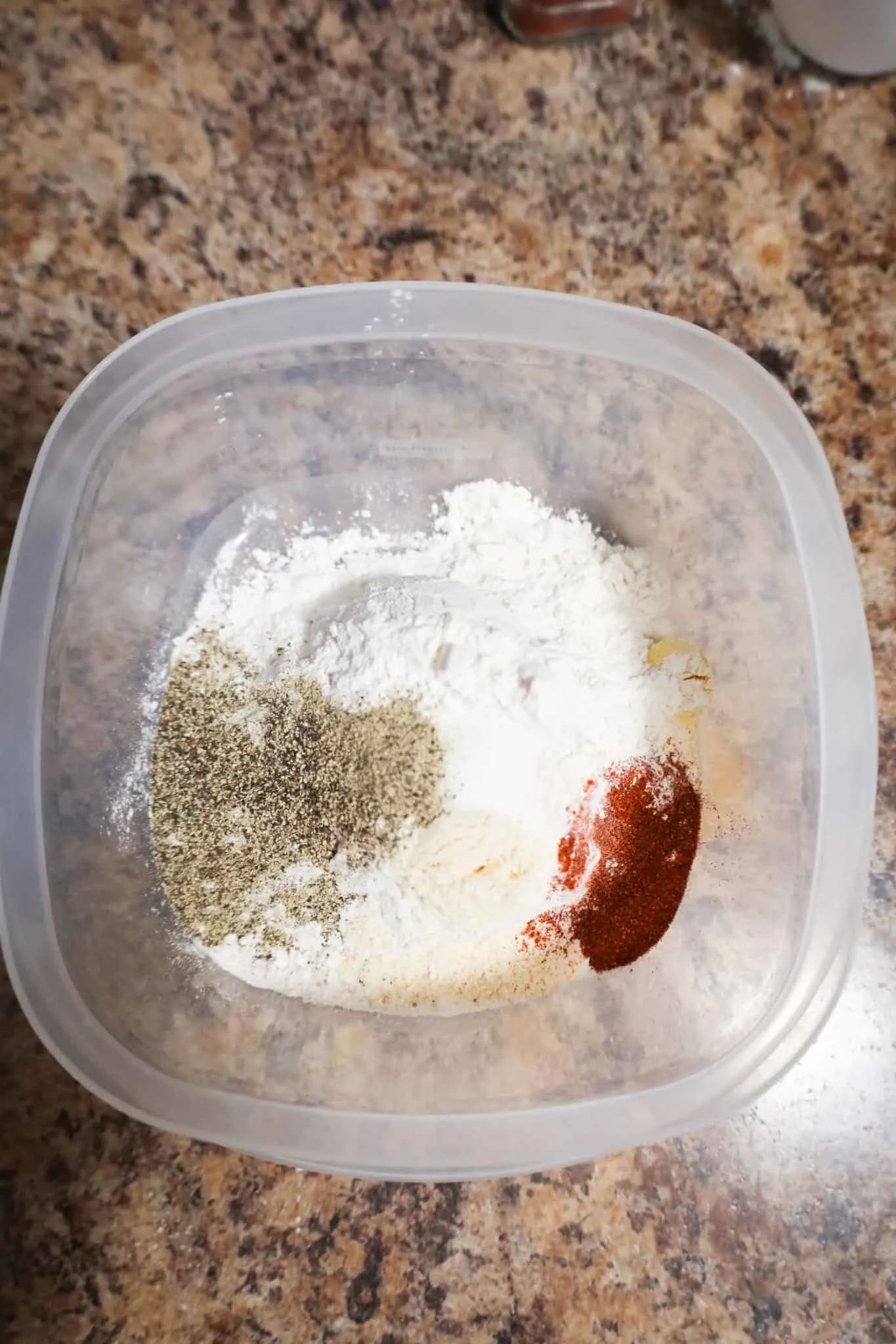 spices on top of all purpose flour in a container