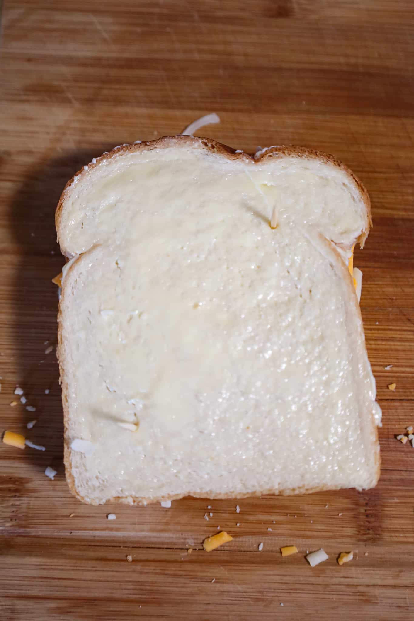 grilled cheese sandwich on a cutting board before cooking