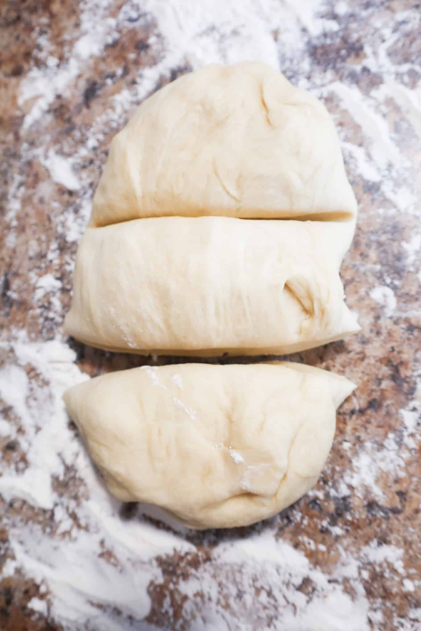 dough on a floured surface cut into 3 pieces