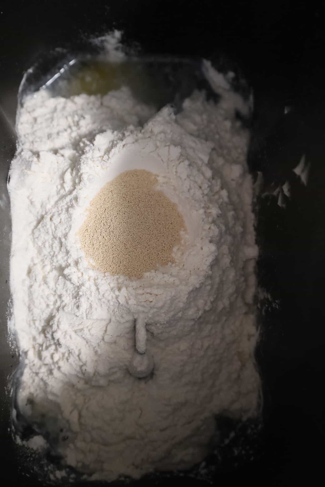 yeast on top of flour in a bread machine pan