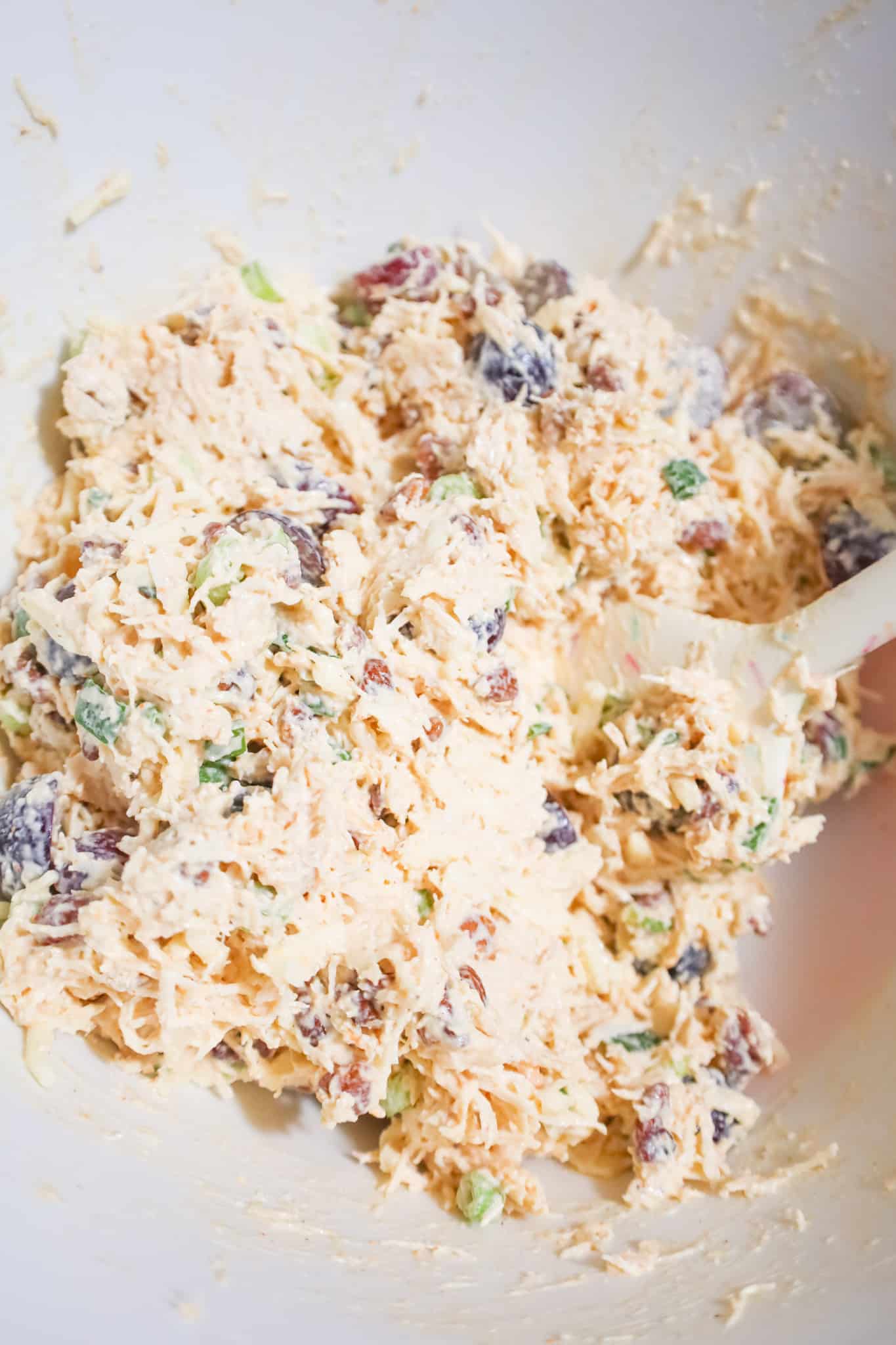 grape and pecan chicken salad mixture in a mixing bowl