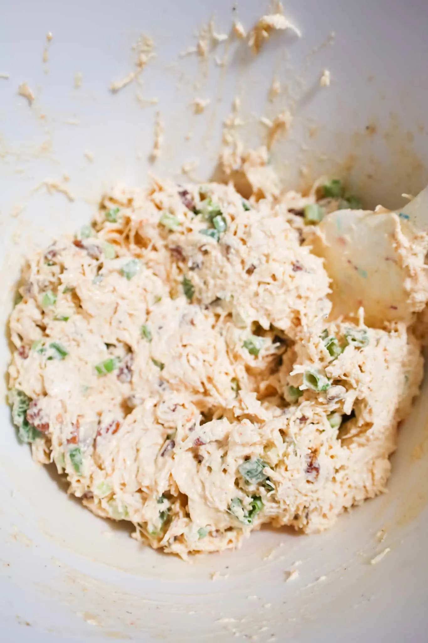 shredded chicken salad mixture in a mixing bowl