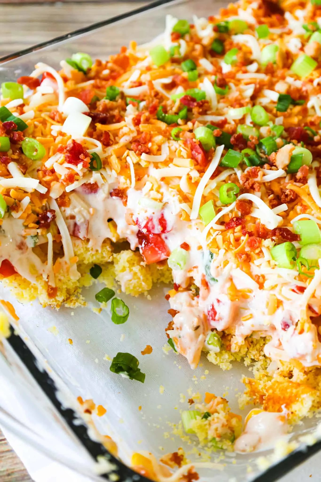 Cornbread Salad is a tasty side dish recipe loaded with cornbread pieces, diced tomatoes, diced bell peppers, corn, shredded cheese, chopped green onions, crumbled bacon and a dressing made from sour cream, ranch and salsa.
