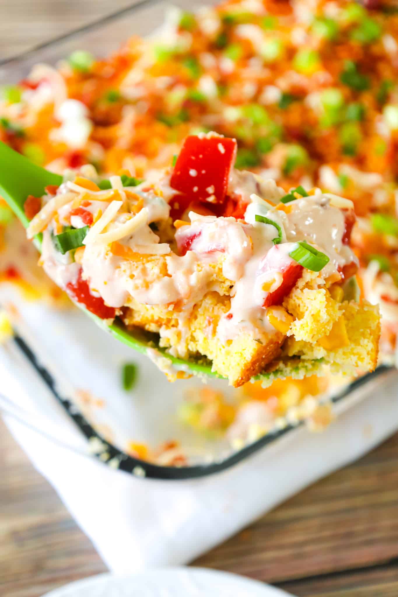 Cornbread Salad is a tasty side dish recipe loaded with cornbread pieces, diced tomatoes, diced bell peppers, corn, shredded cheese, chopped green onions, crumbled bacon and a dressing made from sour cream, ranch and salsa.